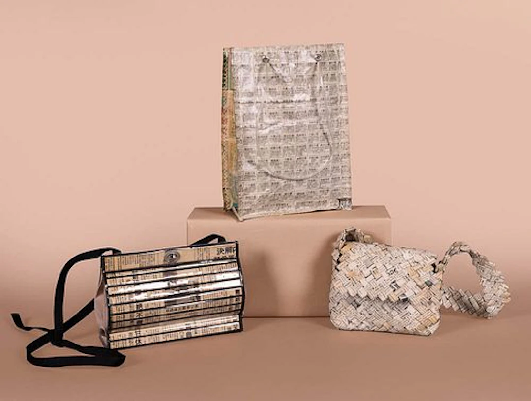 THREE NOVELTY NEWSPRINT HANDBAGS, 1970S - 2000S