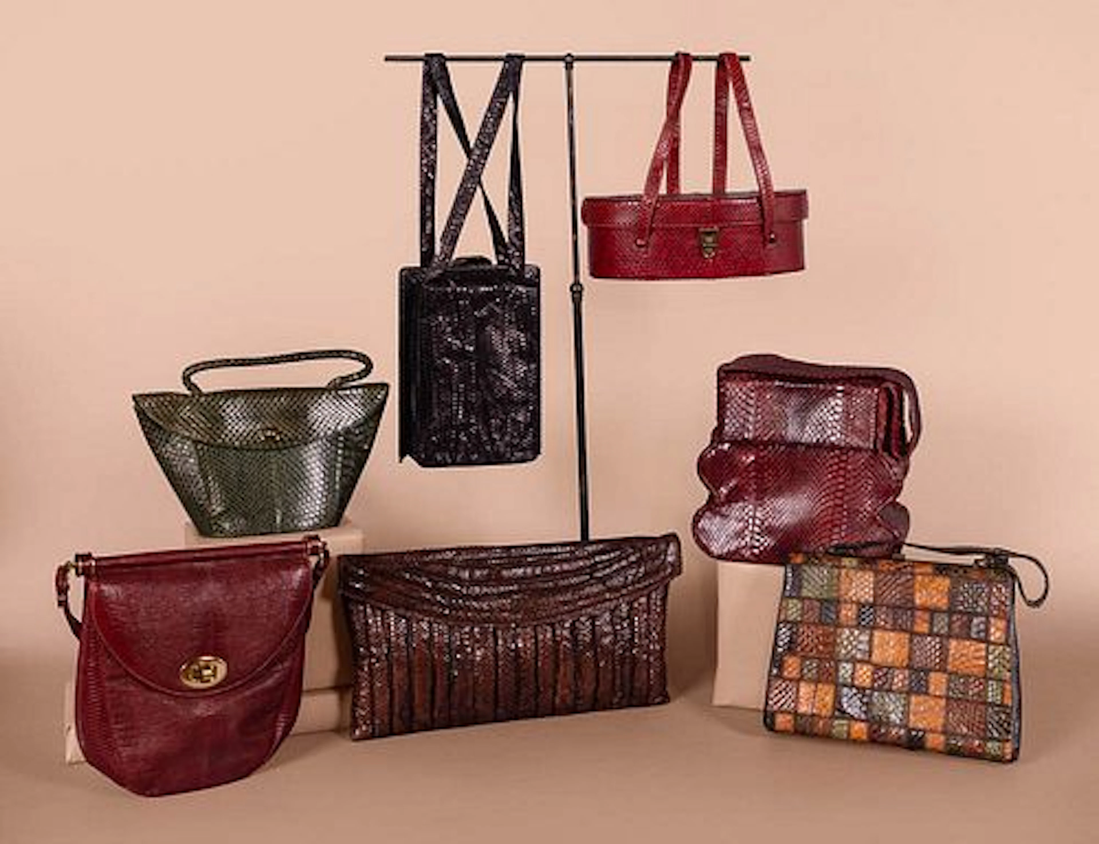 SEVEN REPTILE OR EMBOSSED LEATHER PURSES, MID 20TH C