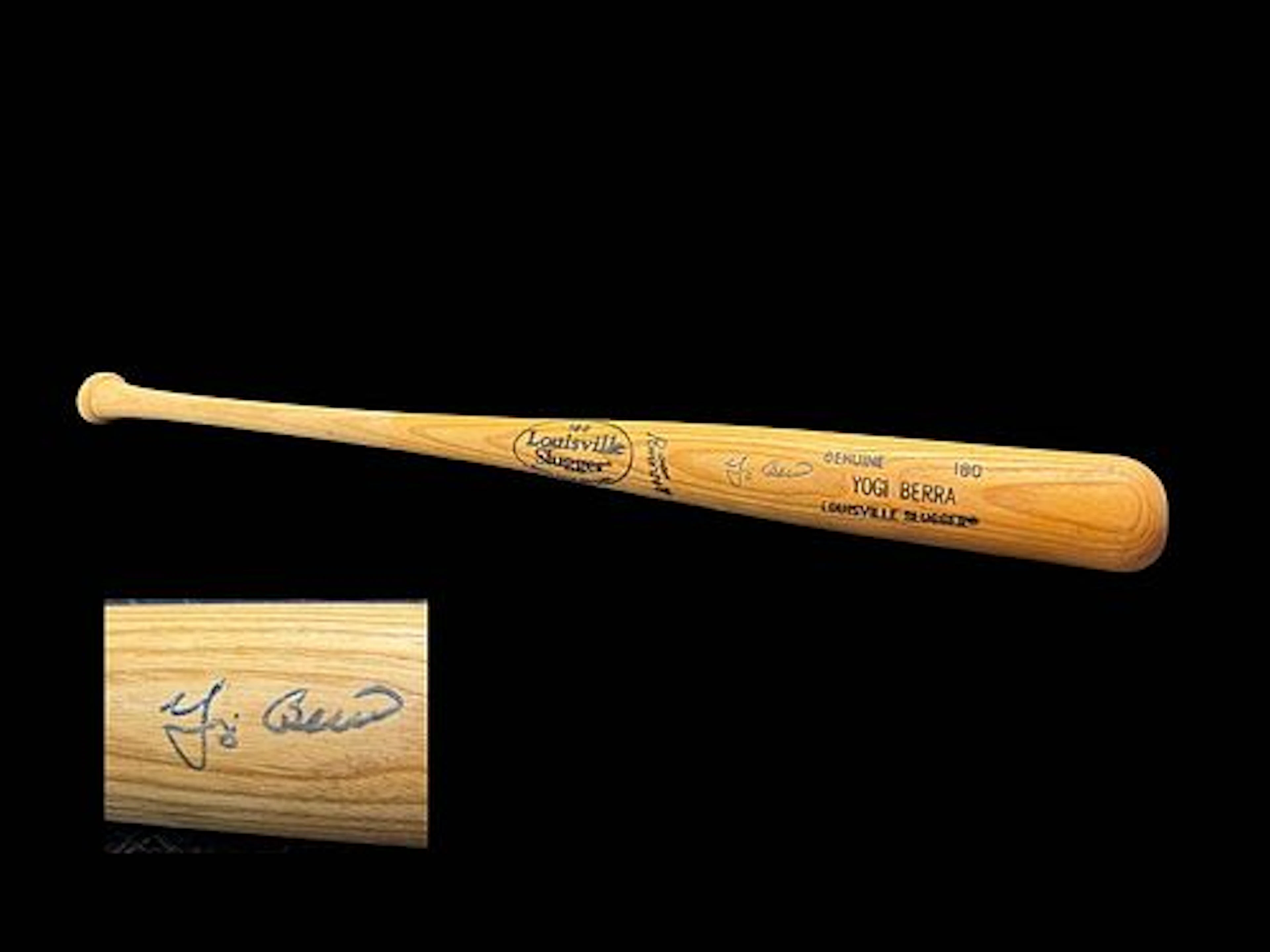 A Louisville Slugger Bat Signed By Yogi Berra