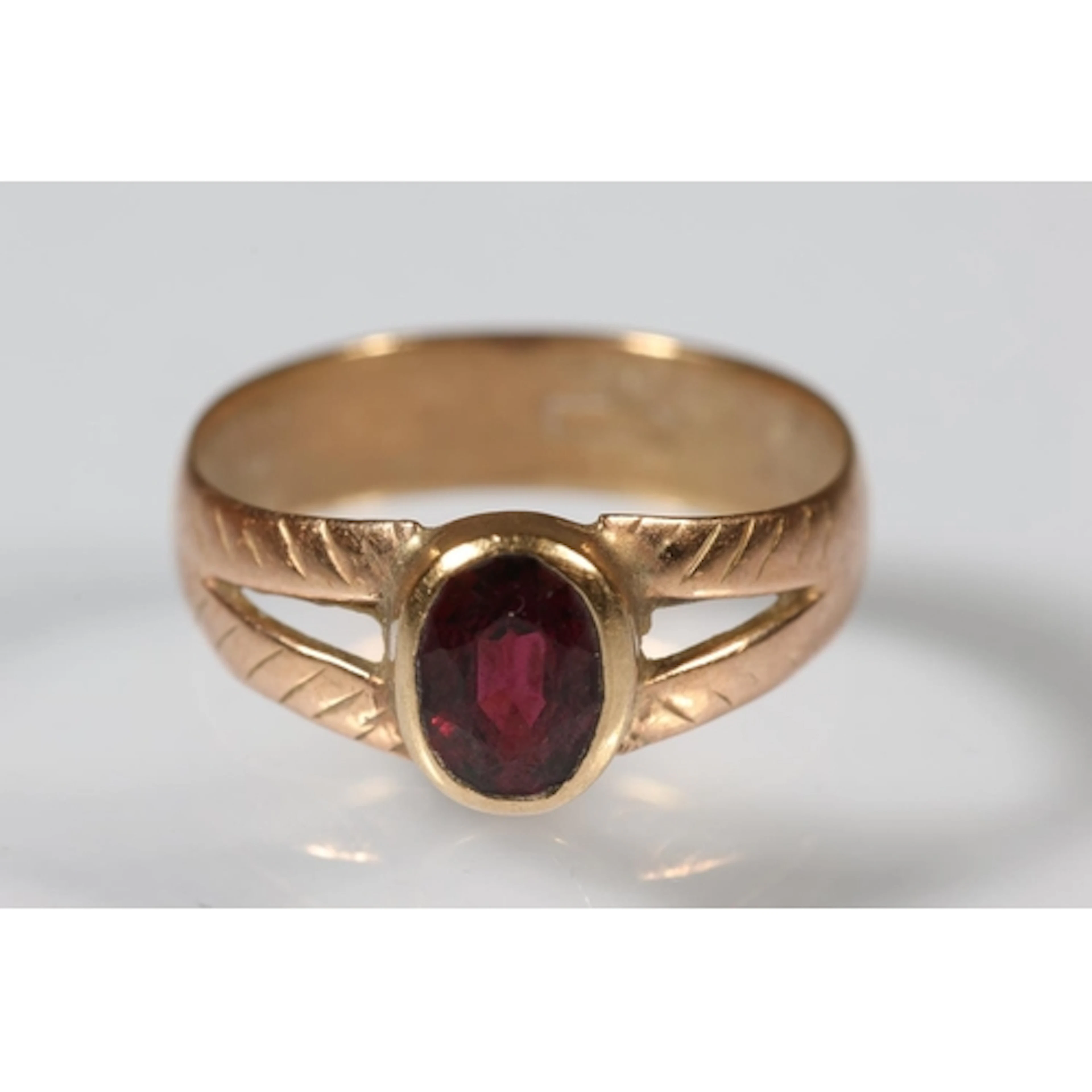 Gold ring set with faceted garnet stone, marks rubbed, size ...