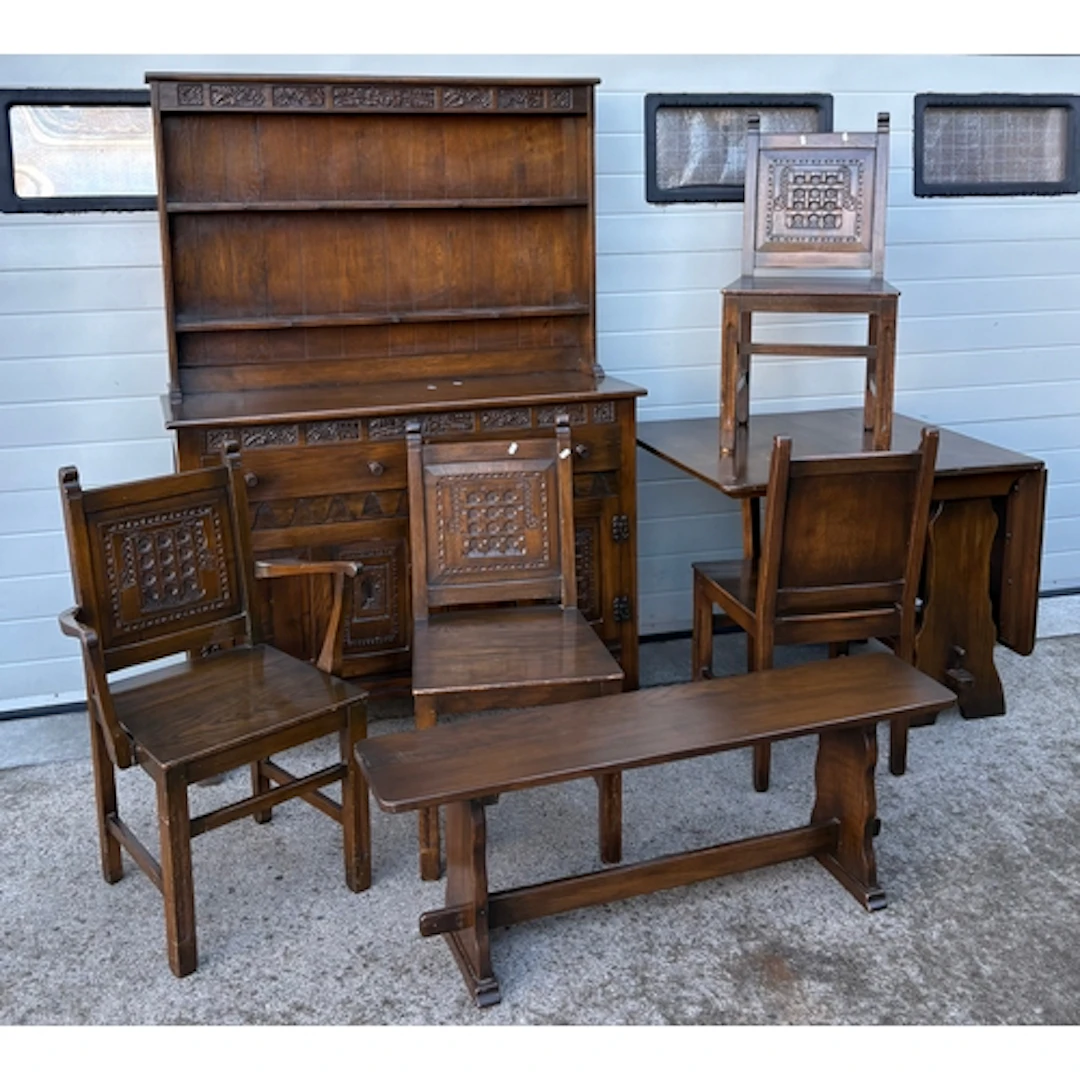 An oak dining room suite to include dresser, drop leaf table...