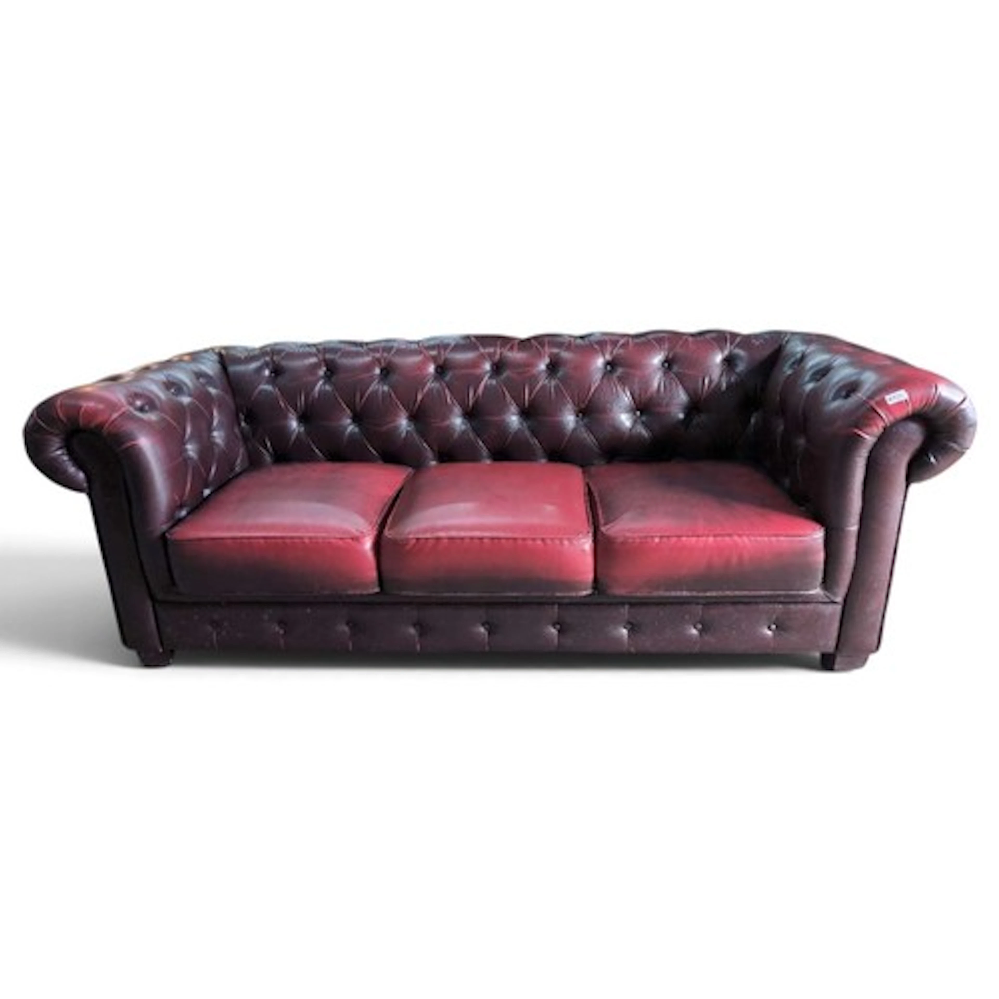 Red leather-effect Chesterfield-style 3-seater sofa.