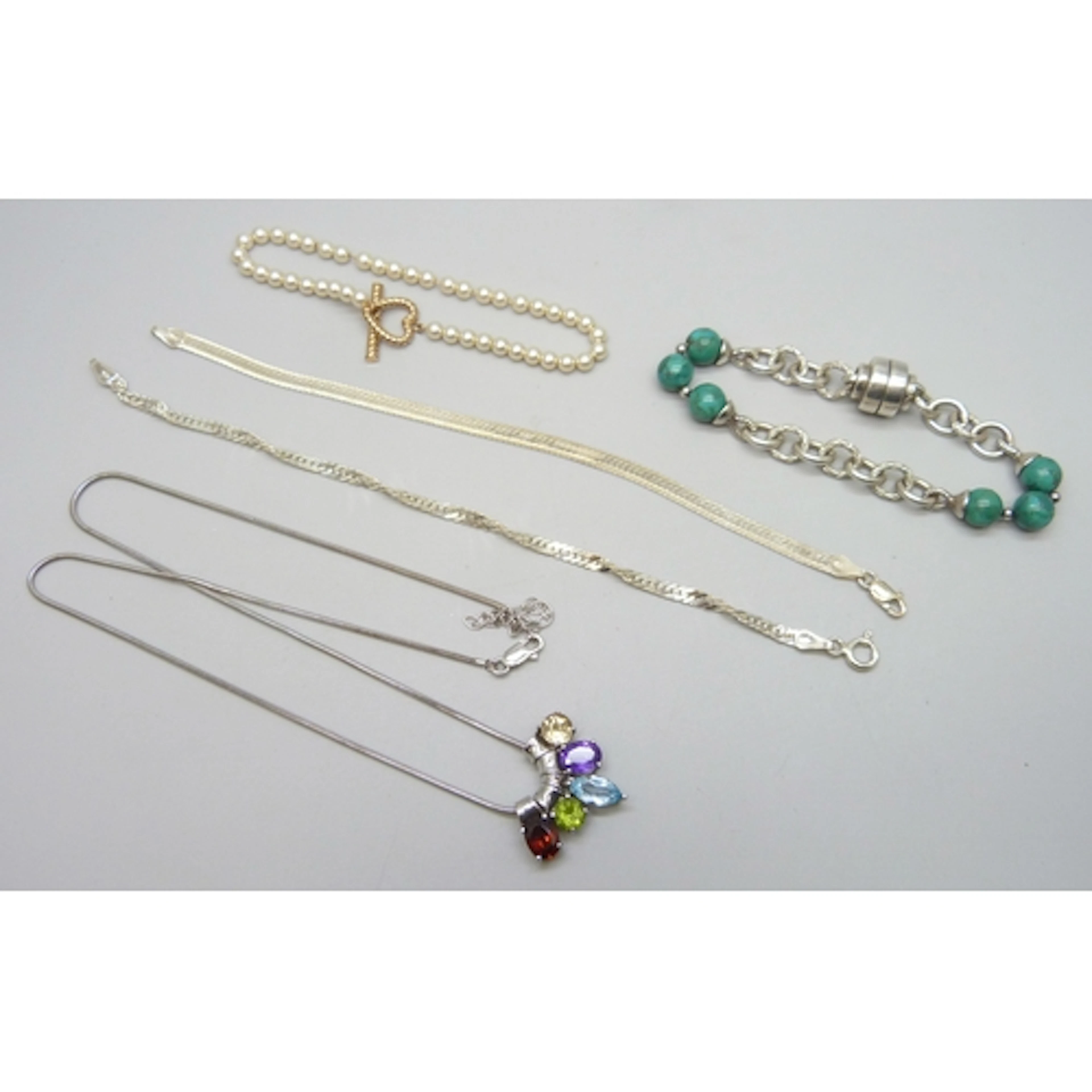 Two silver bracelets, a Fossil steel heart clasp faux pearl ...