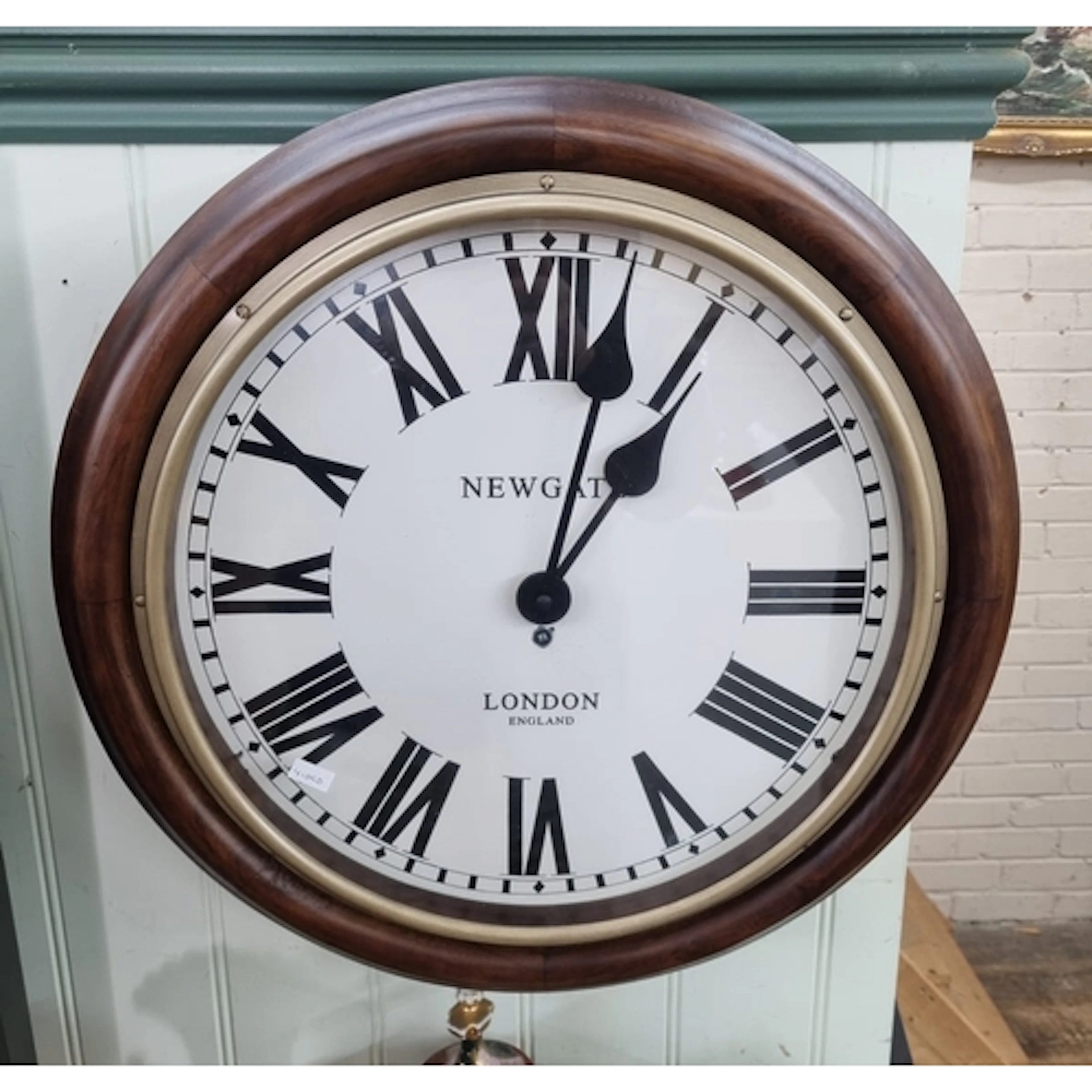 A circular modern school type clock in mahogany case, Newgat...