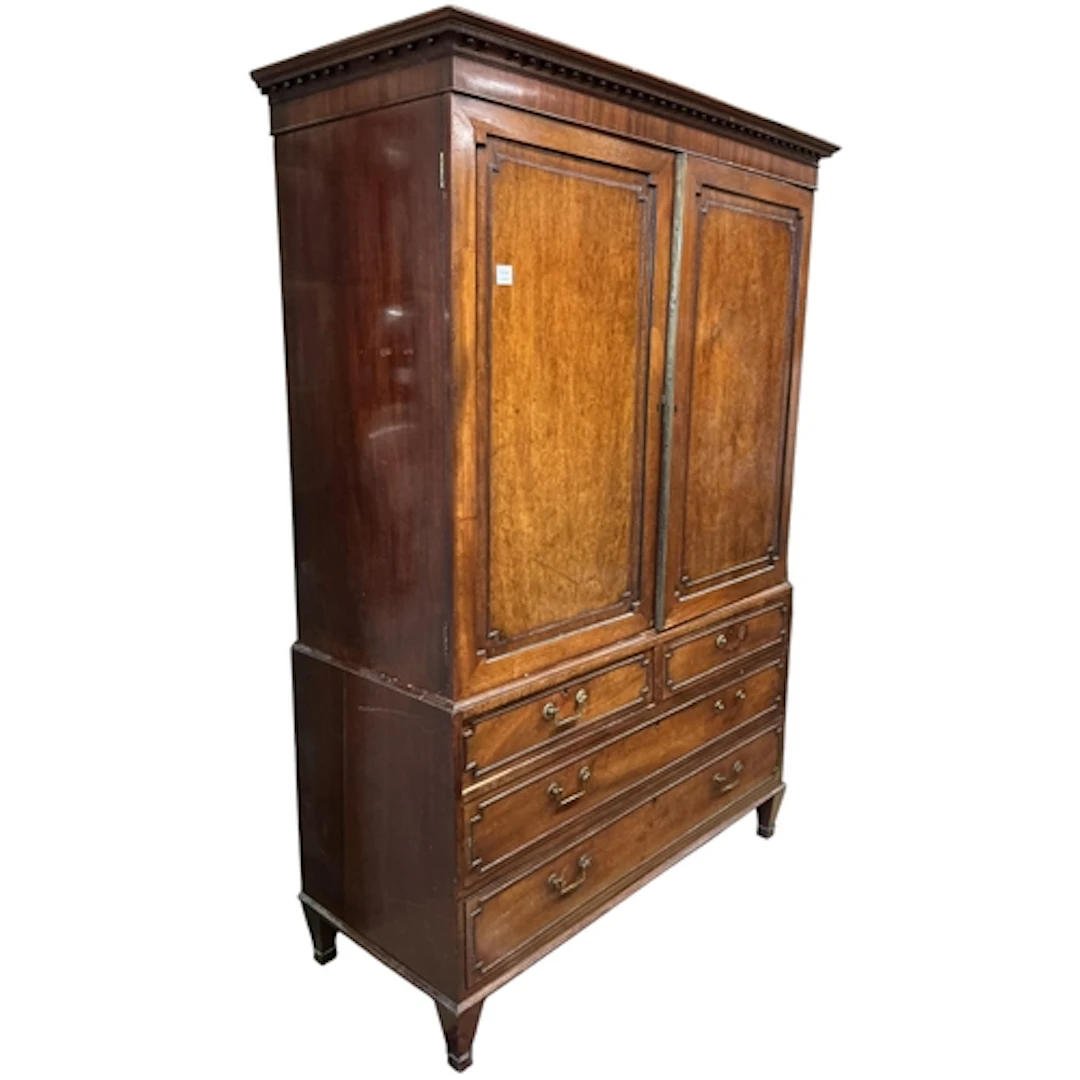 A Regency mahogany linen press, with twin cupboard doors ove...
