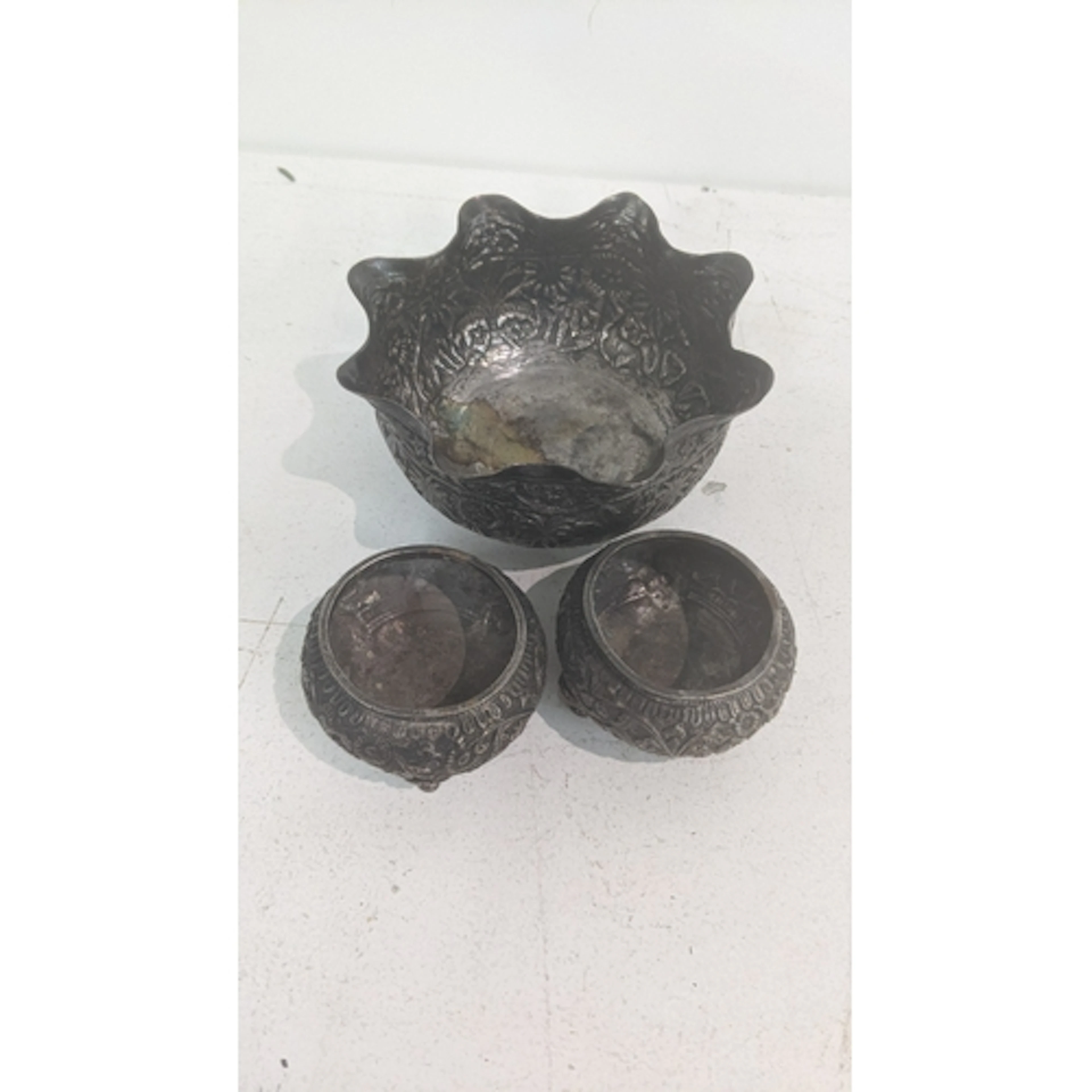 An Indian white metal sugar bowl having a flared rim, along ...