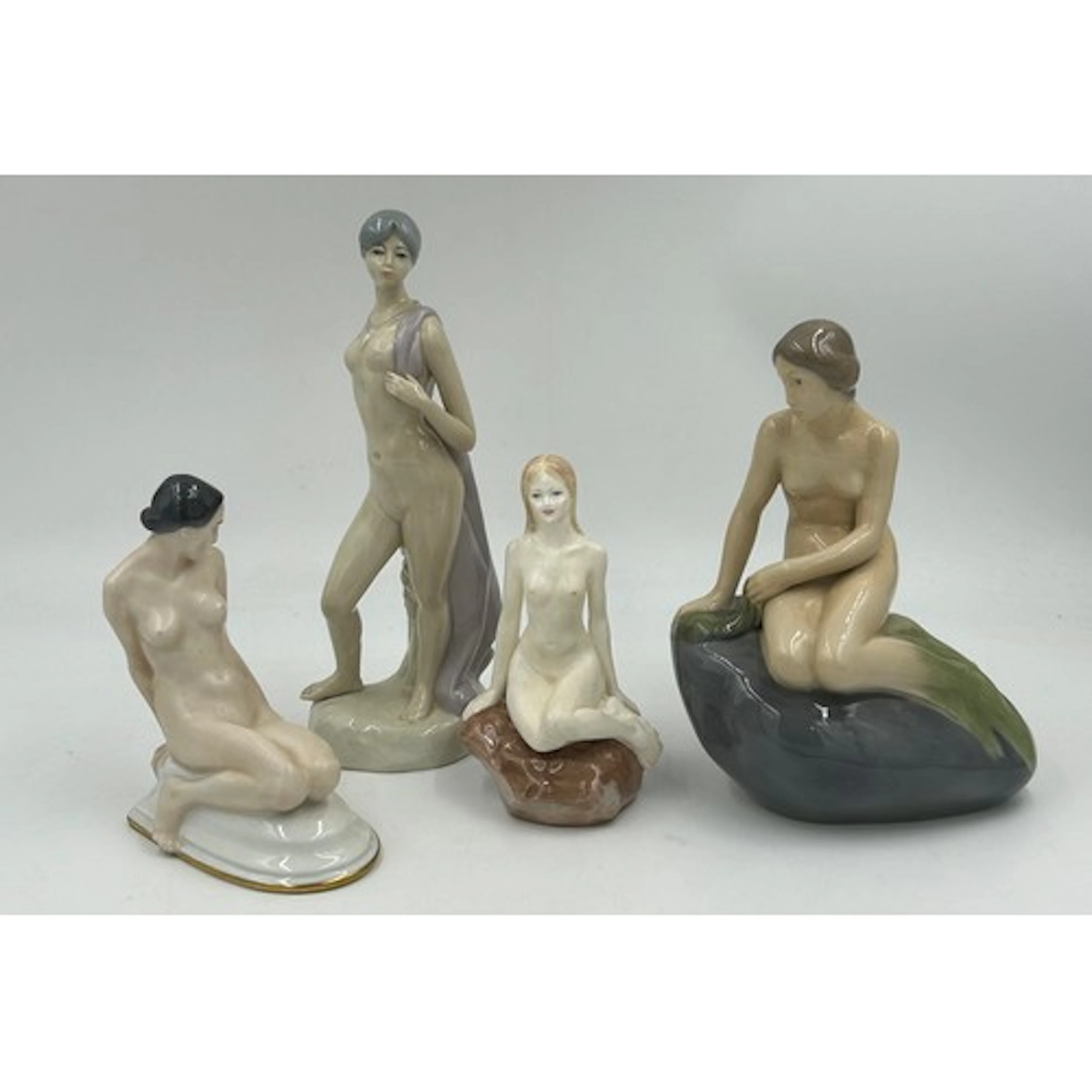 Four 20thC figurines comprising: Schlaggenwald, Bohemia, a k...