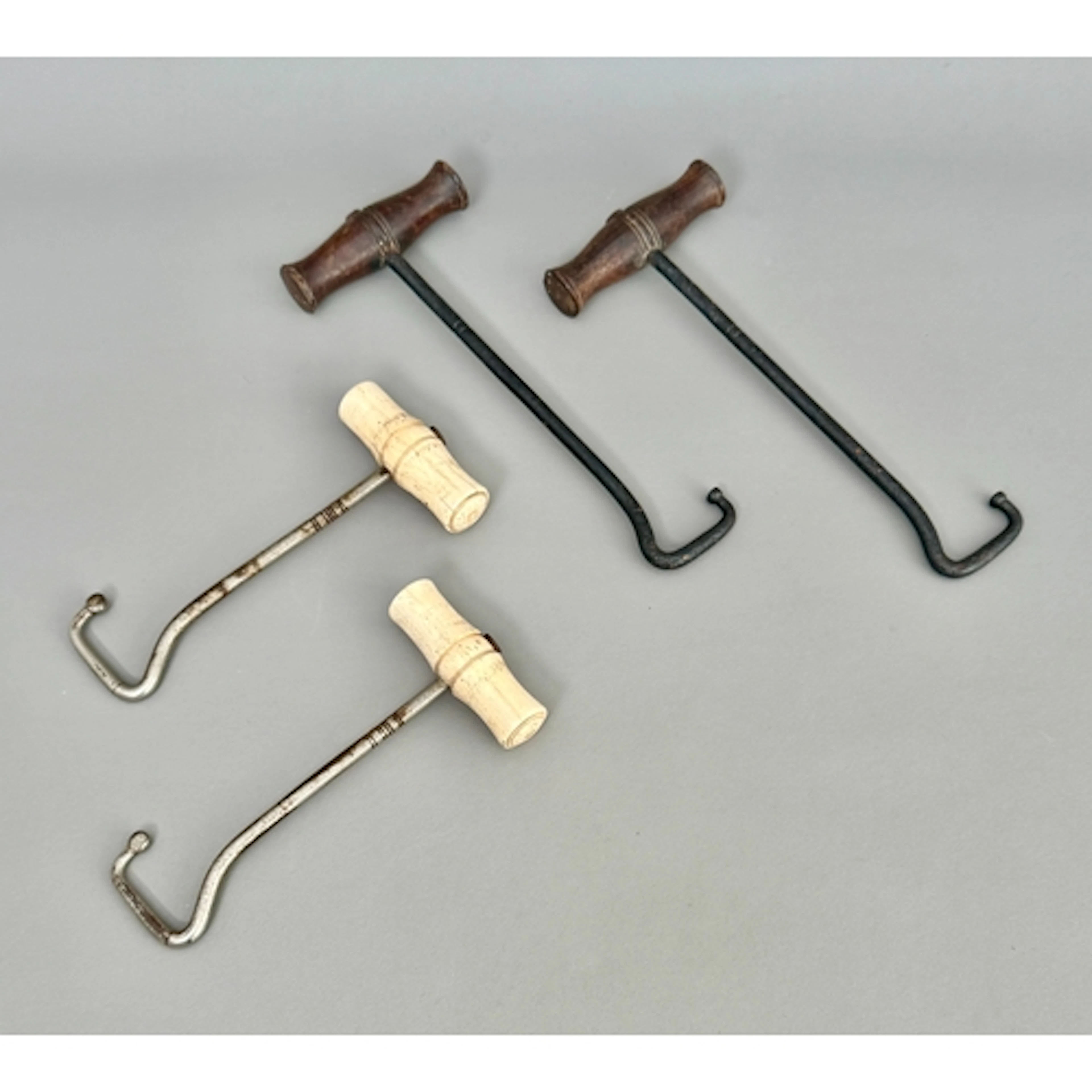 Two pairs of antique riding boot pulls - one pair with turne...