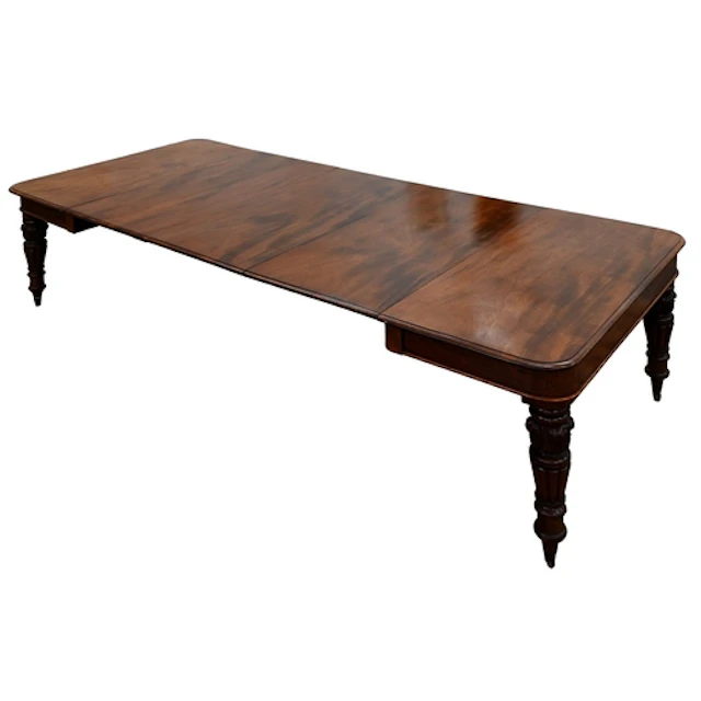 A Victorian mahogany dining table, the rounded rectangular t...
