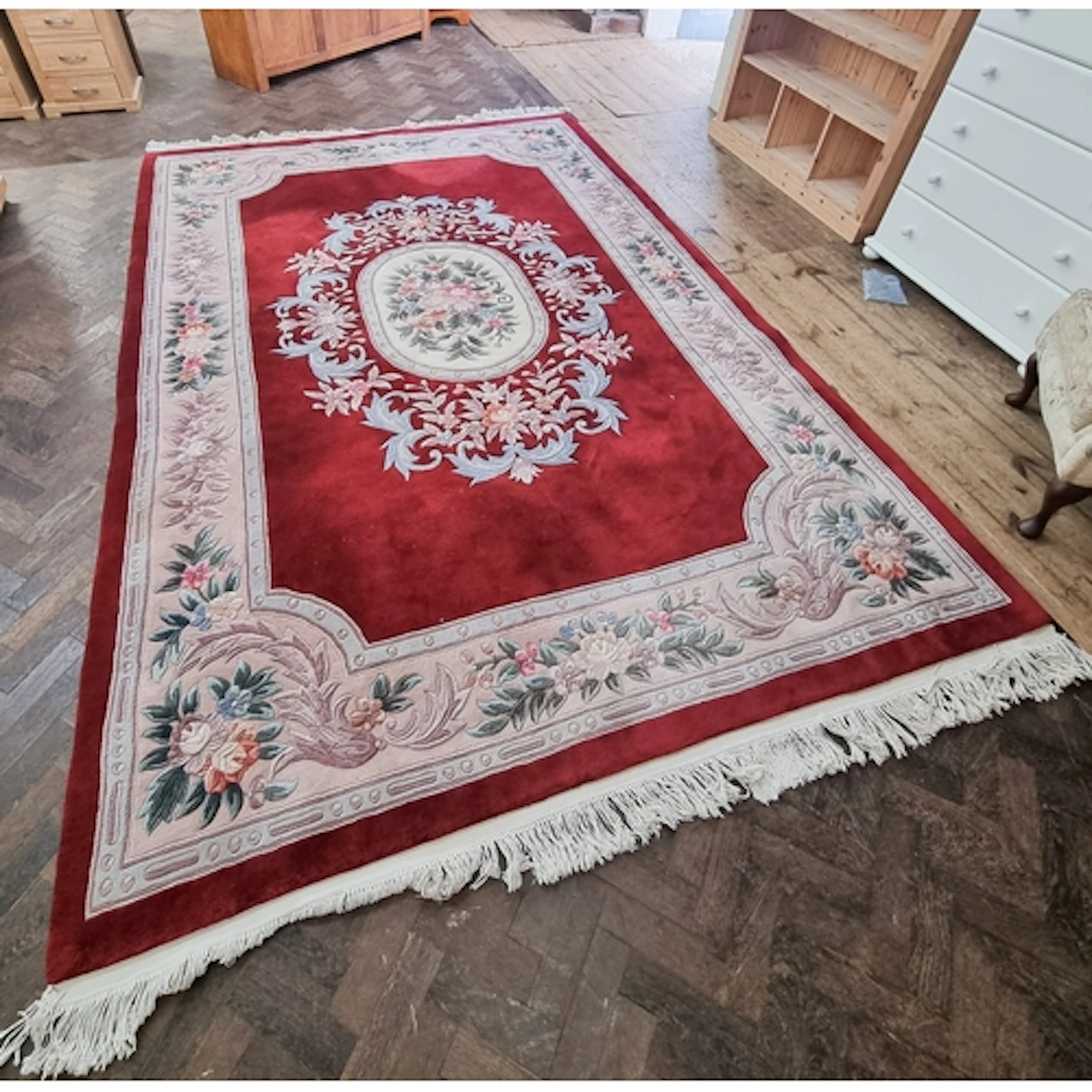A modern Chinese red figured rug in good condition, measurin...