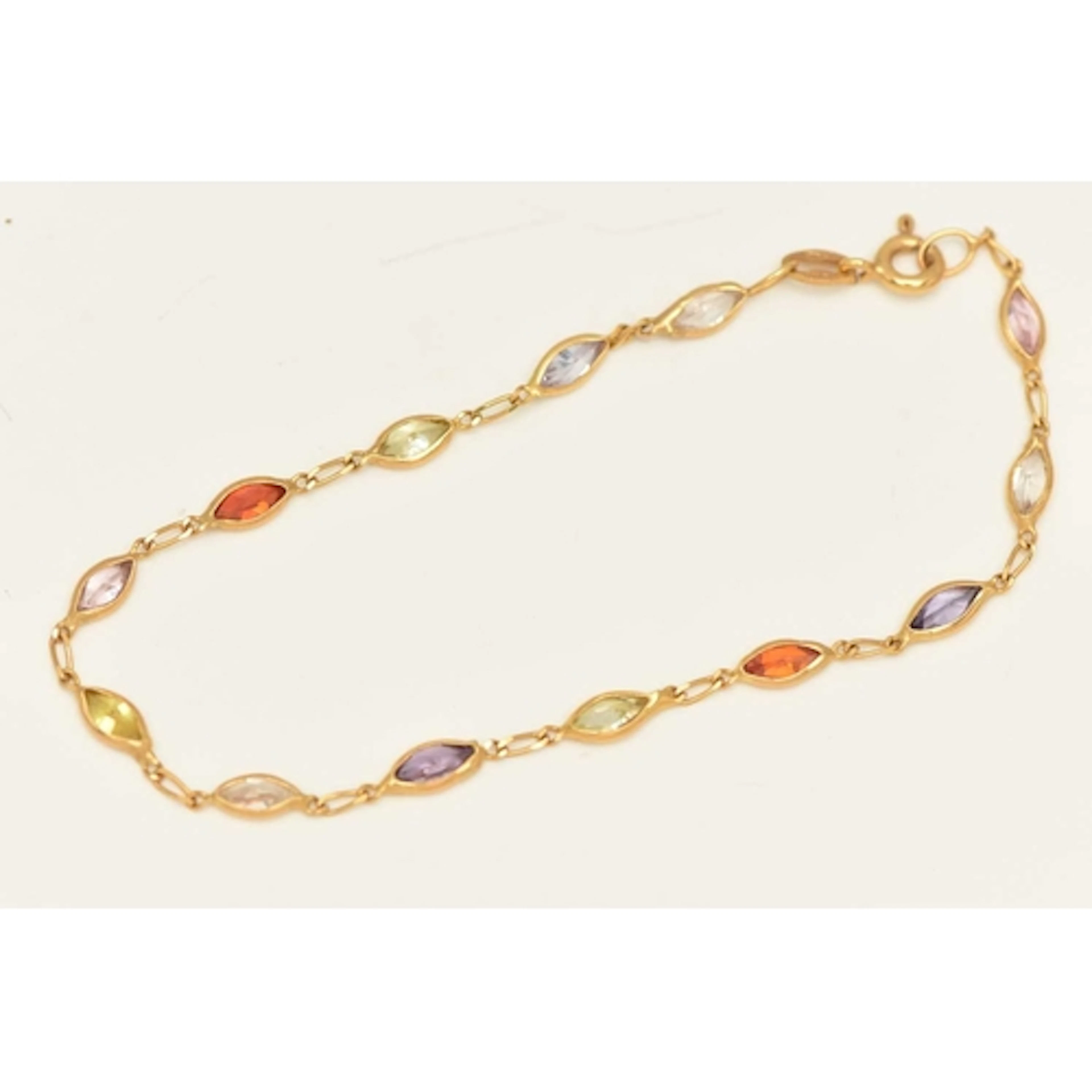 A YELLOW METAL CZ BRACELET, spectacle set with multi-colour ...