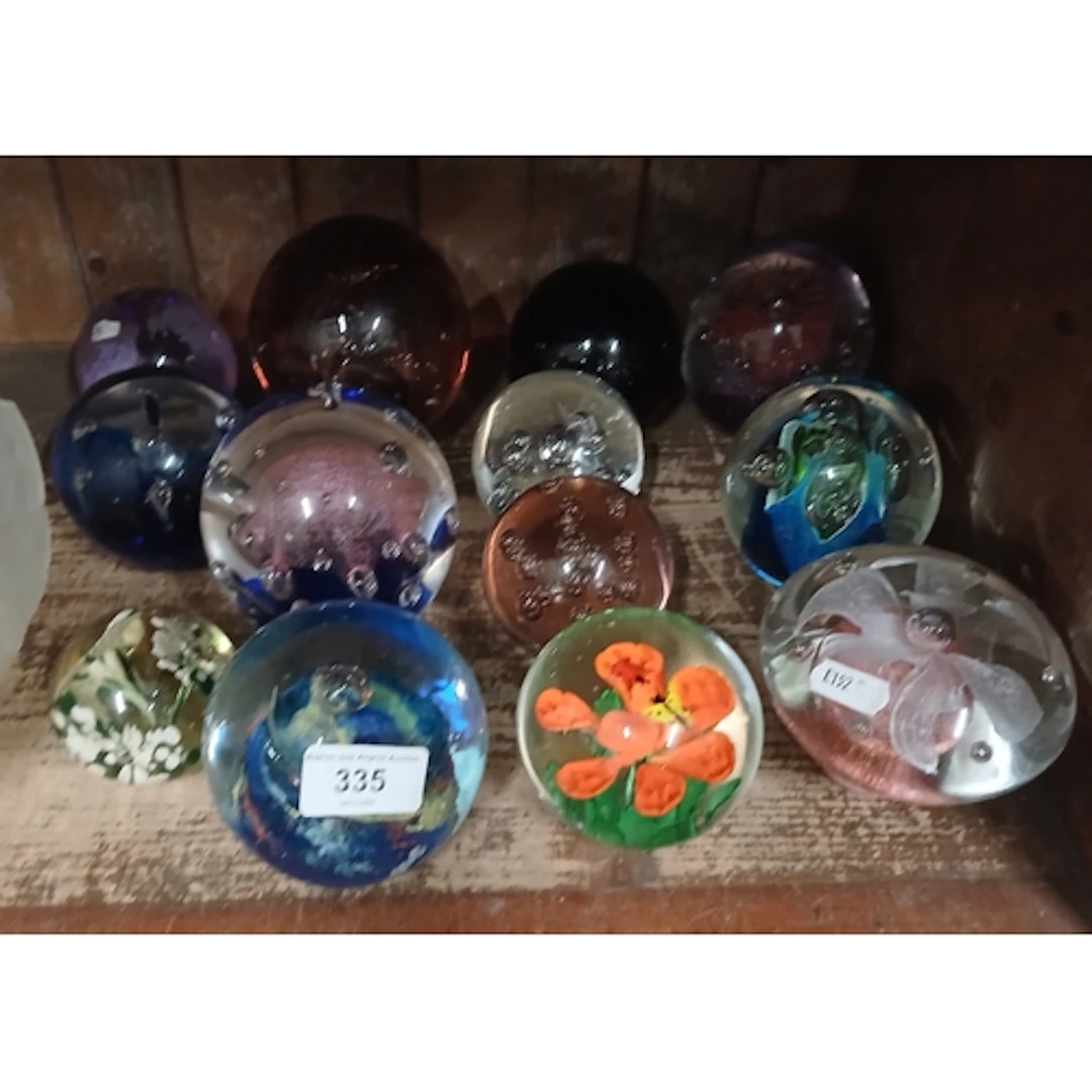 13 glass paperweights.