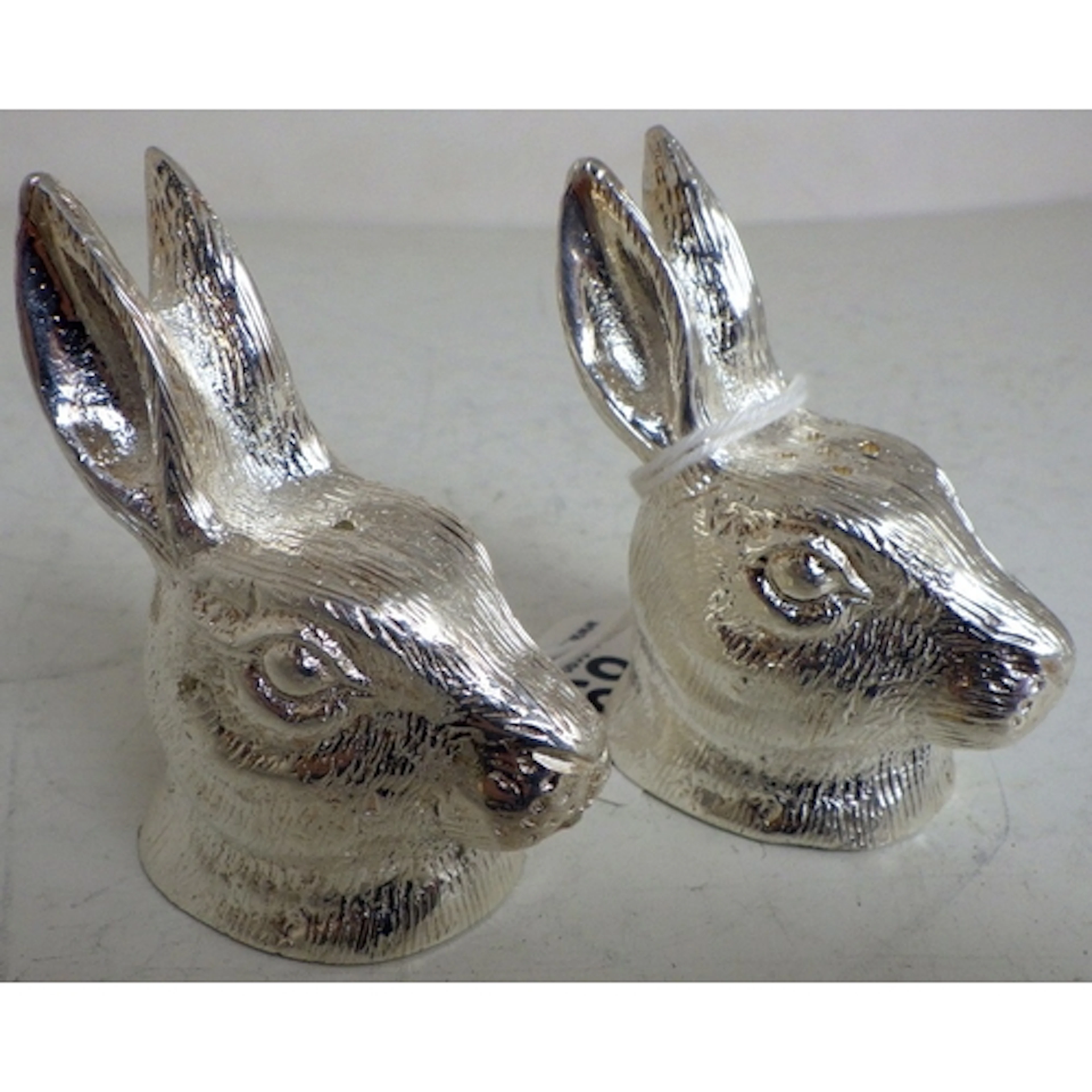 A pair of silver plated salt & pepper pots in the form of ra...