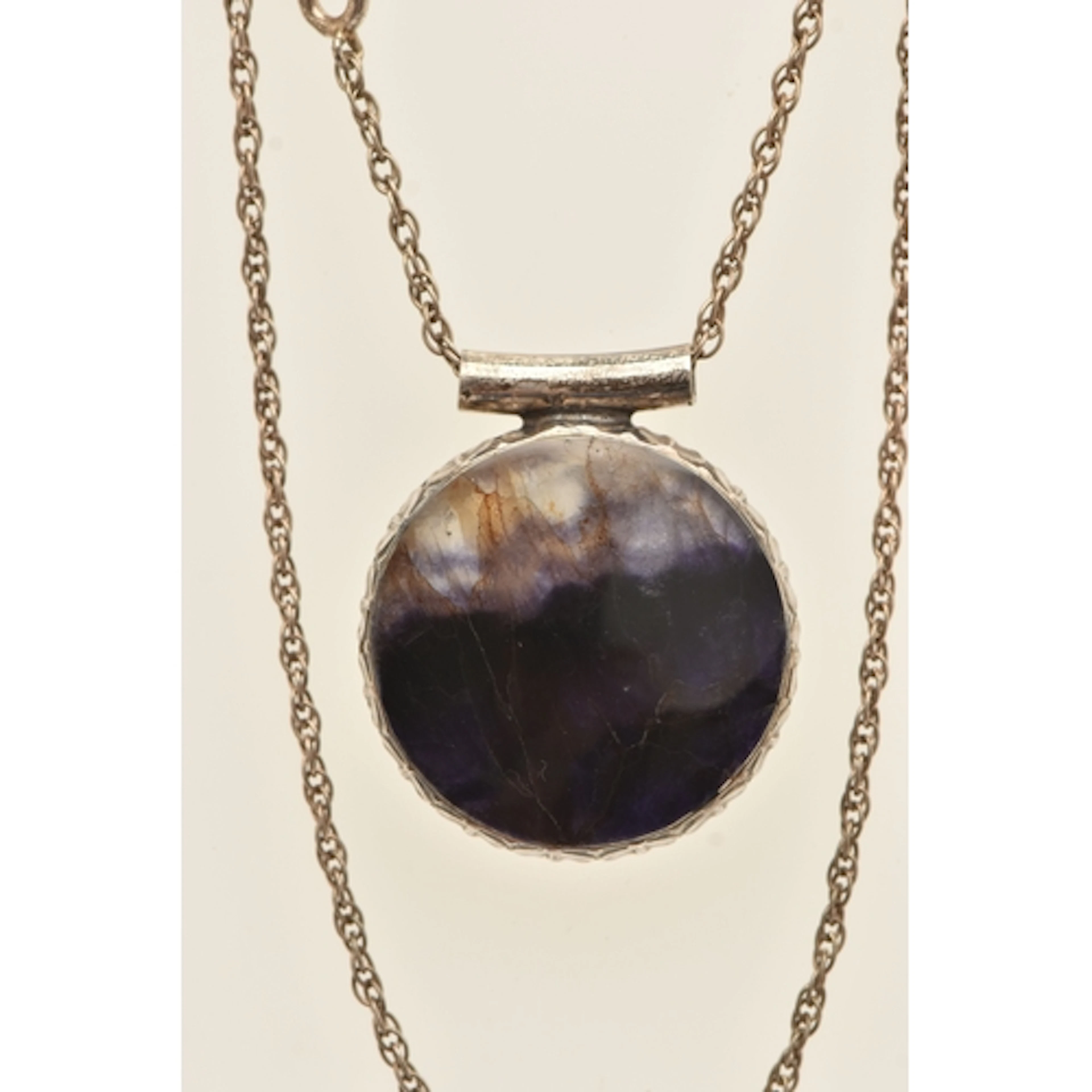 A SILVER BLUE JOHN PENDANT NECKLACE, the pendant of a circul...