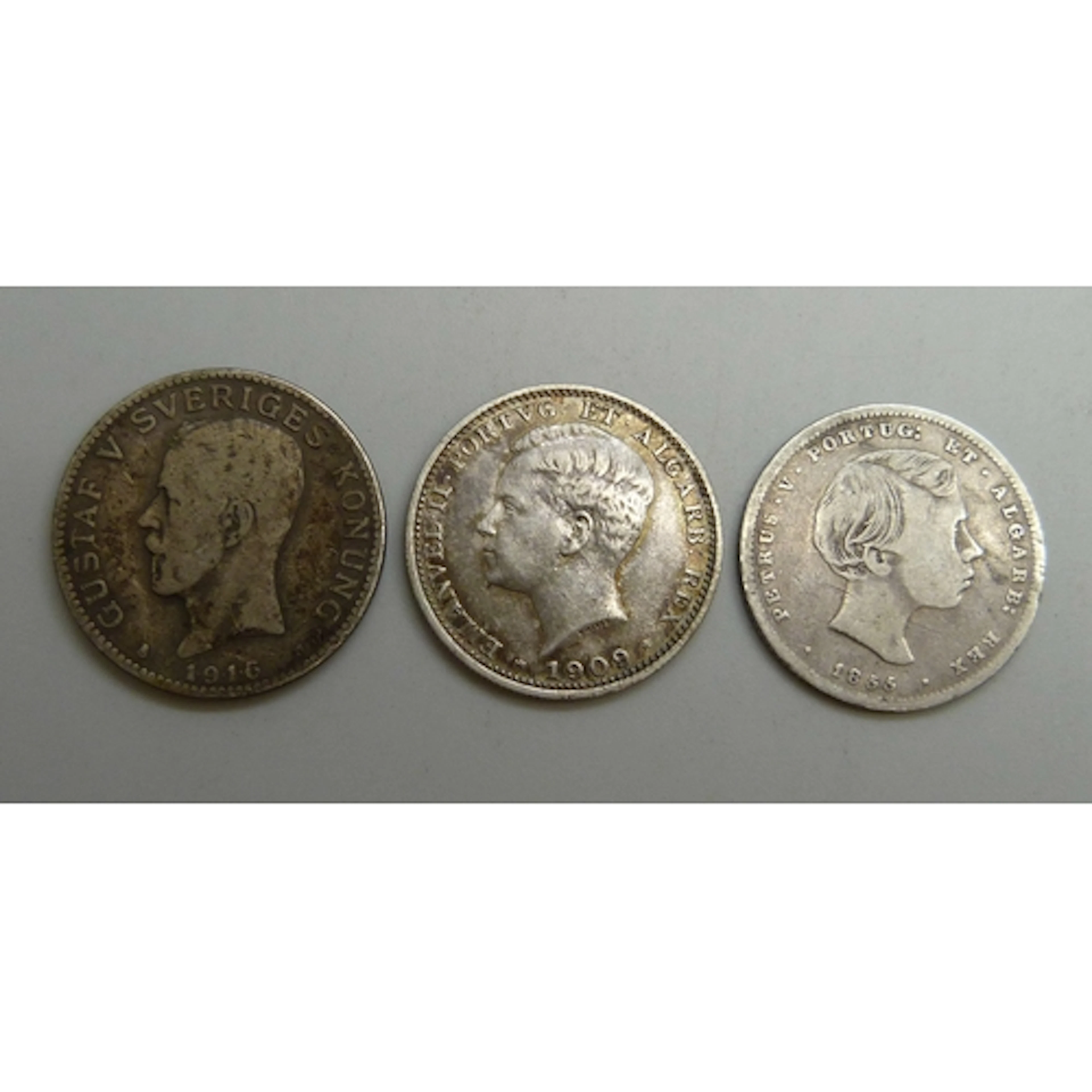 Two Portuguese 200 reis coins, and a Swedish 1 krona coin, 1...