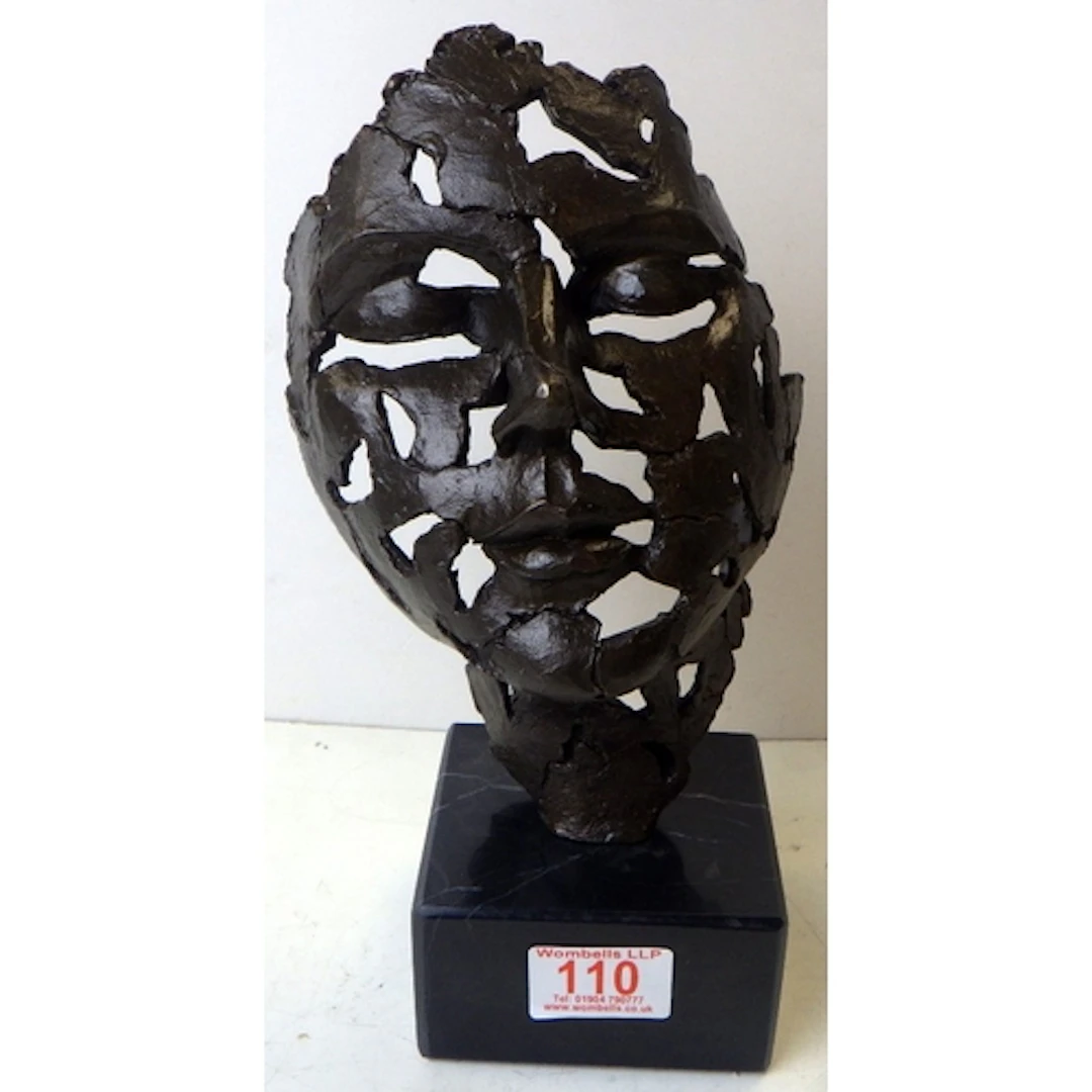 A bronze abstract figure of a Mask, 28cm tall