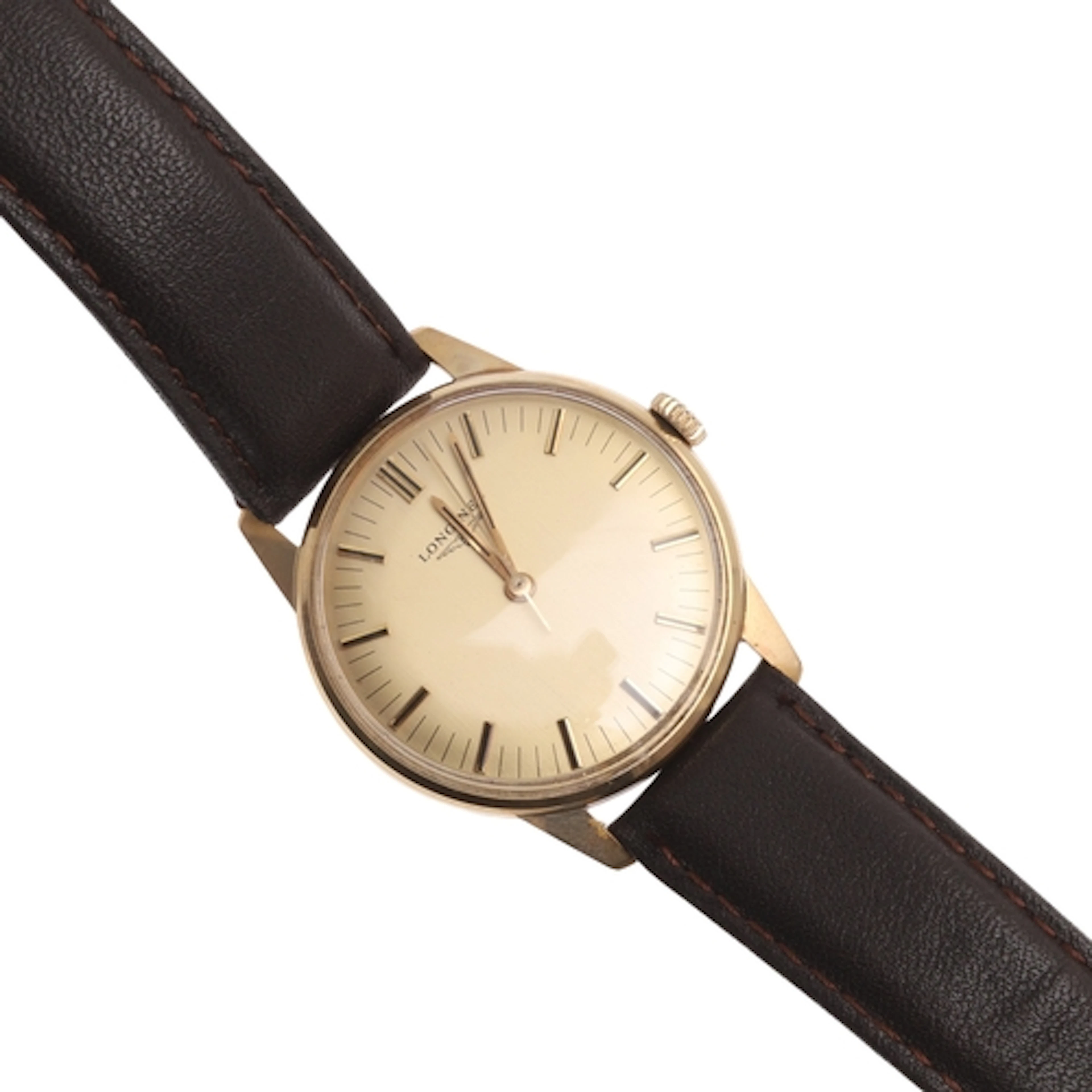 A GENTLEMAN'S GOLD WRISTWATCH BY LONGINES. the signed gold c...
