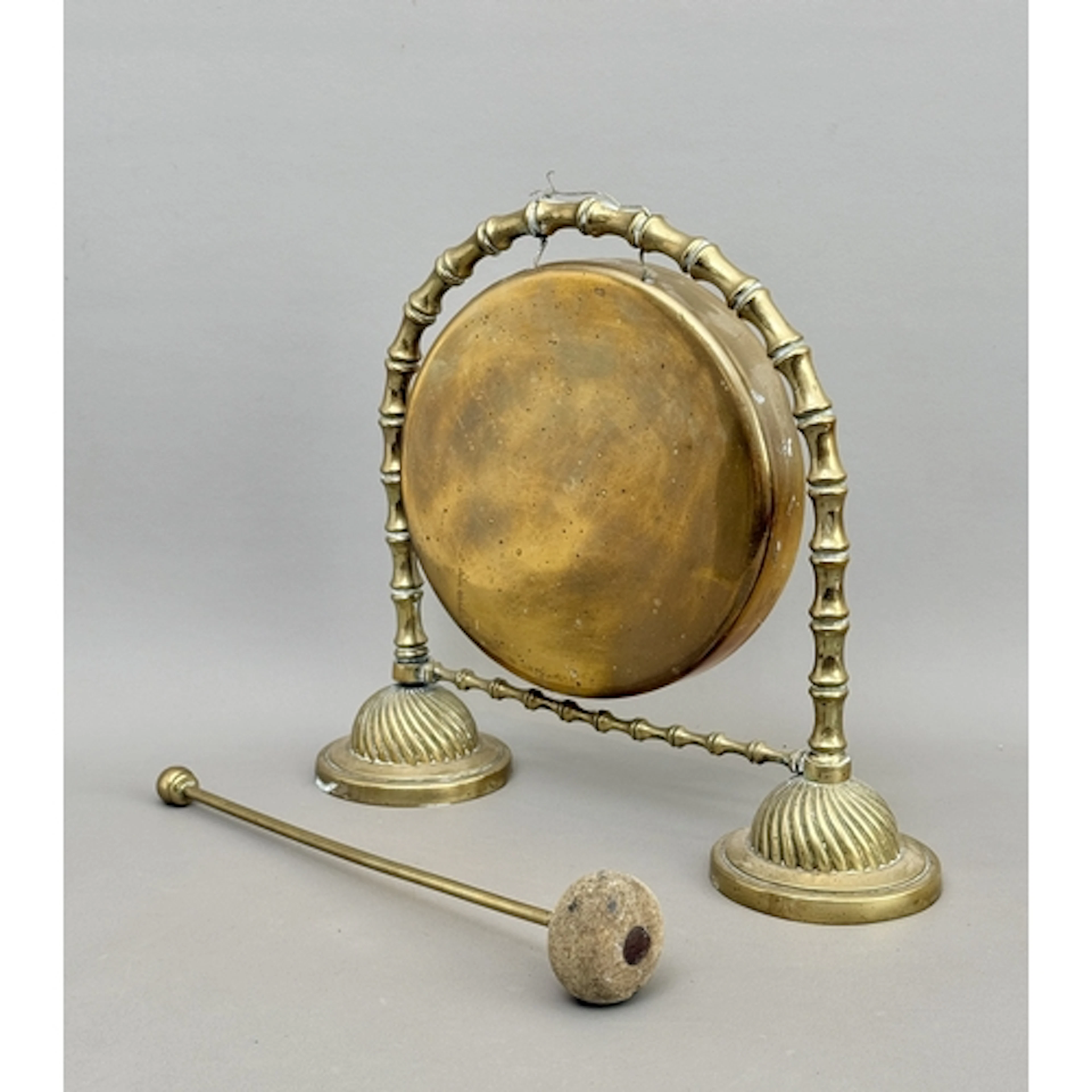 A Victorian brass tabletop dinner gong with imitation bamboo...