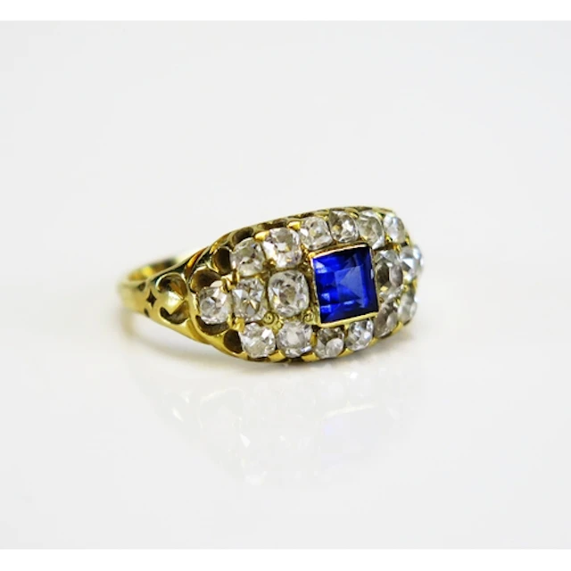 A synthetic sapphire and old European cut diamond cluster ri...