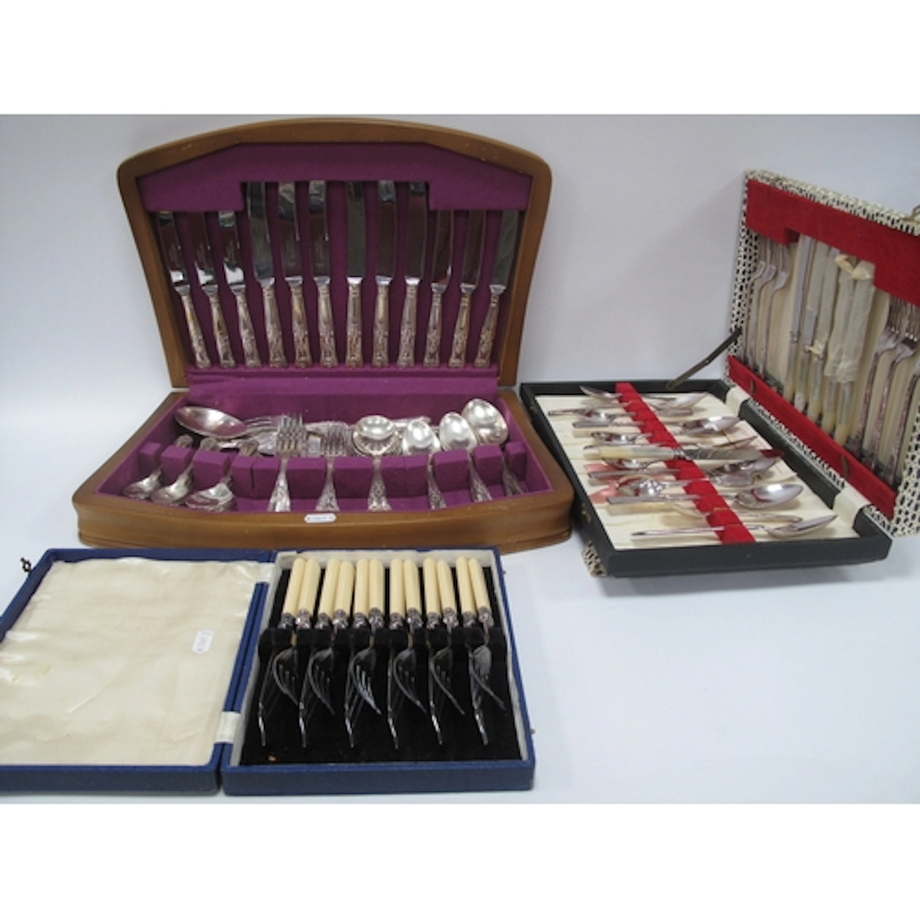 Three cased sets of cutlery, comprising a canteen of silver-...