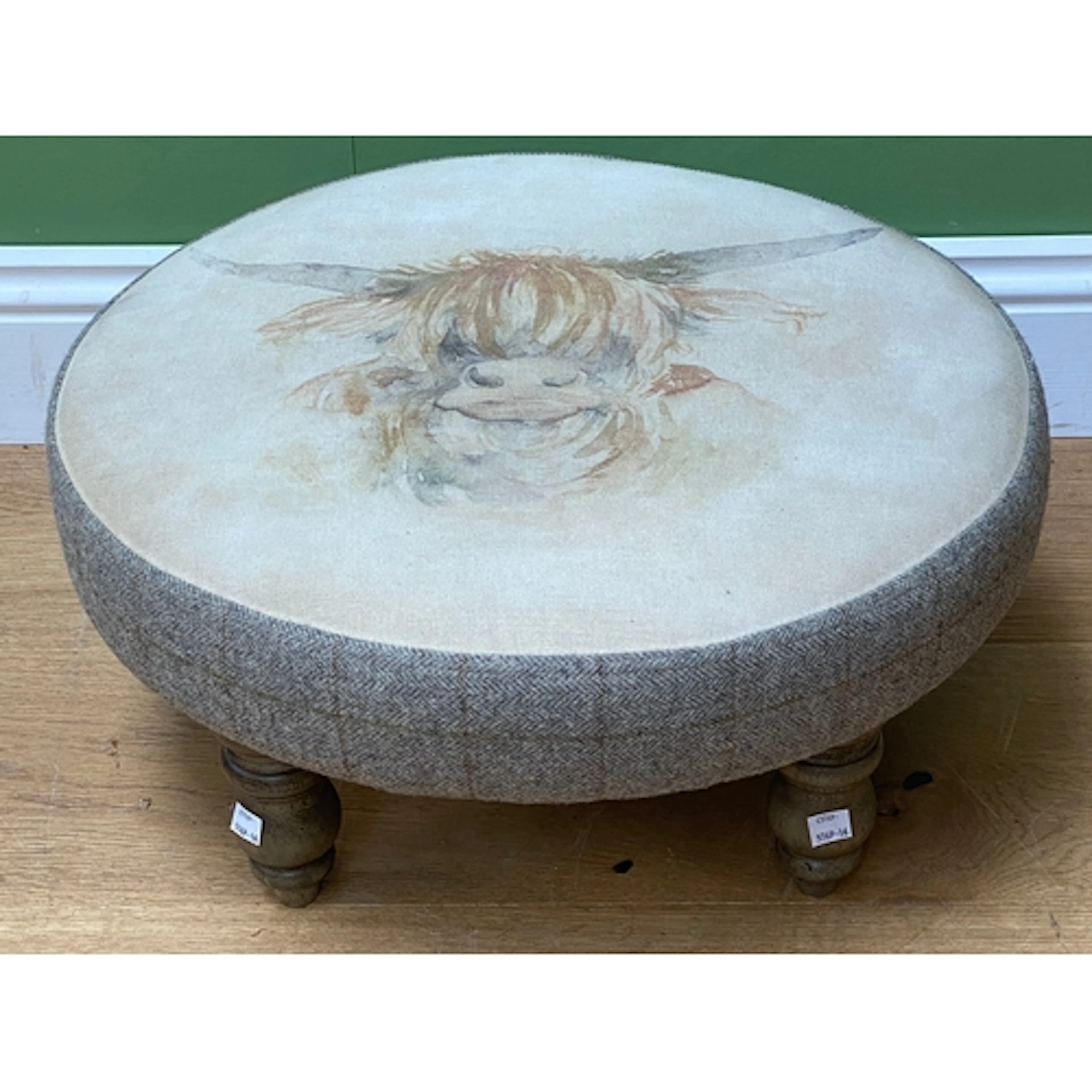 A Voyage Maison circular upholstered foot stool, depicting a...