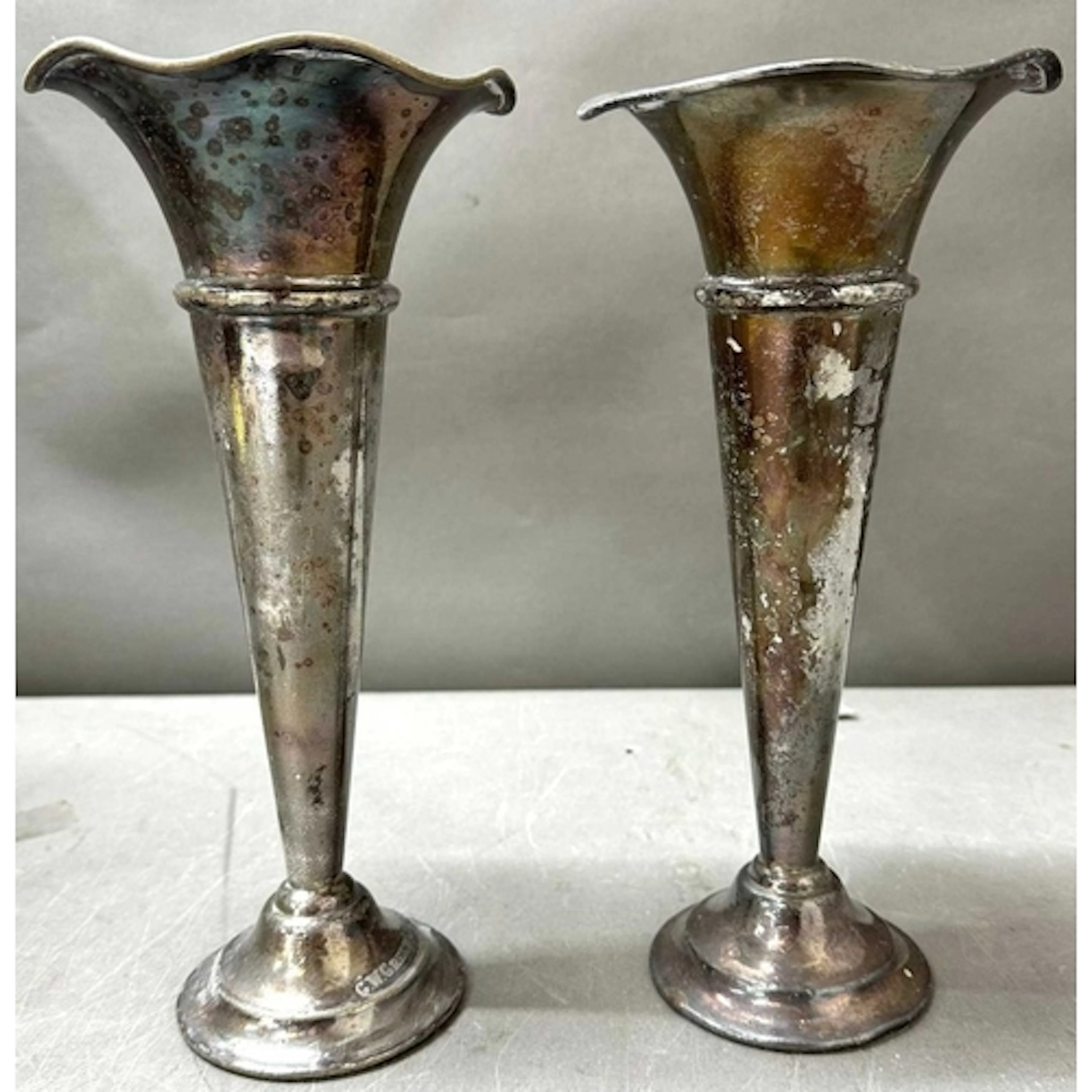 A pair of silver plated trumpet candlestick holders with a w...