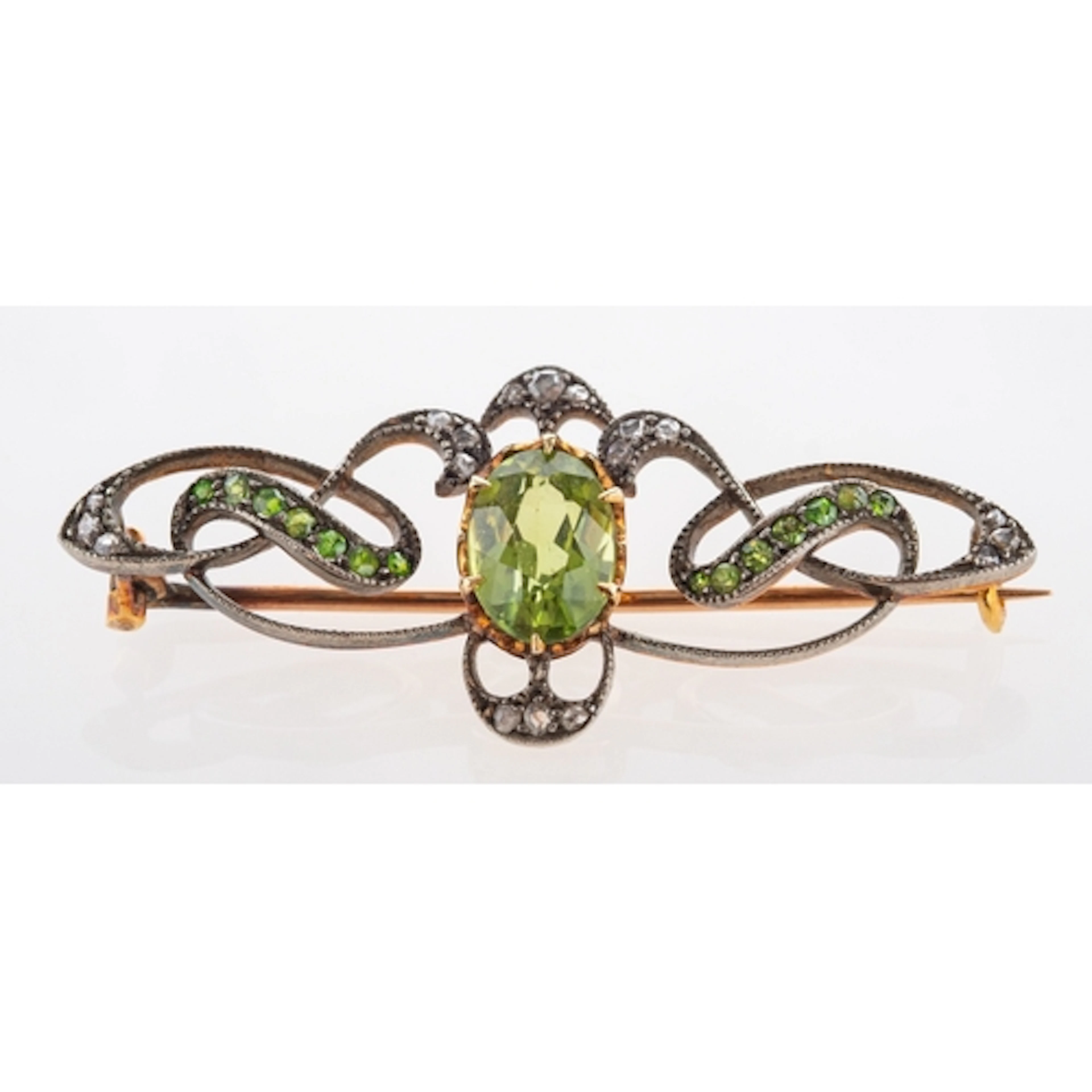 A peridot and demantoid garnet, Art nouveau yellow metal bro...
