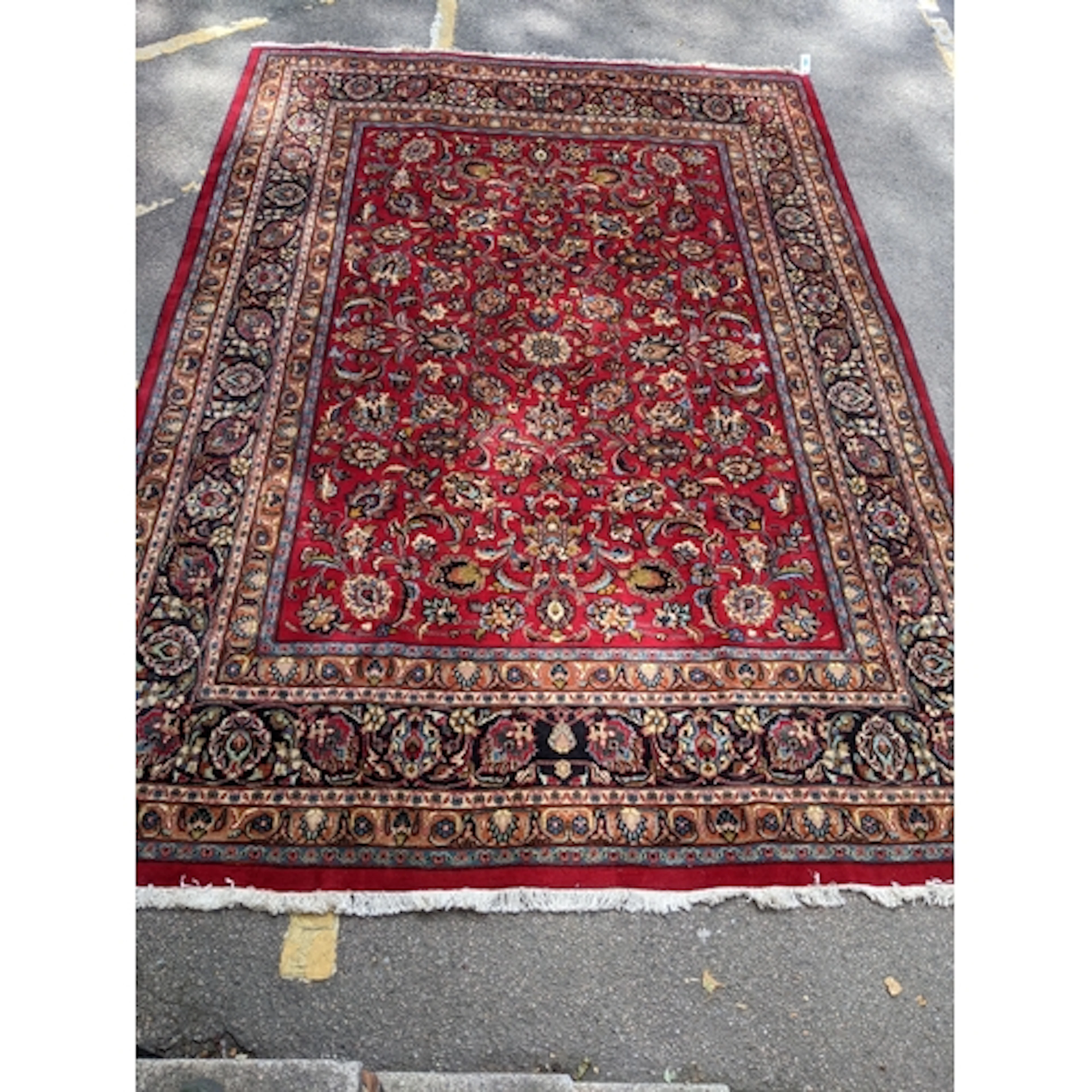 A vintage Mashad hand-woven carpet, red ground, all over flo...