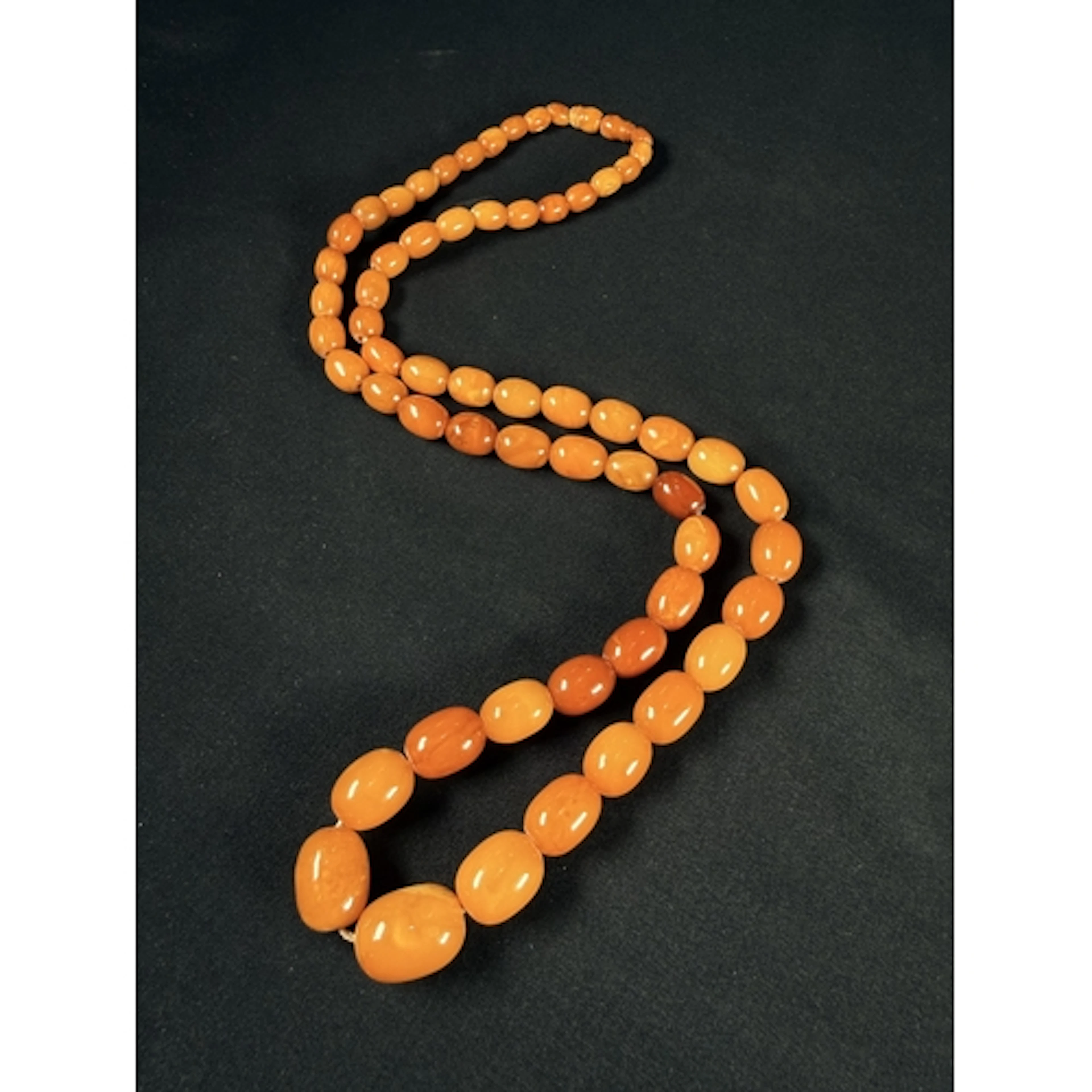 A graduating string of Butterscotch amber beads, length appr...