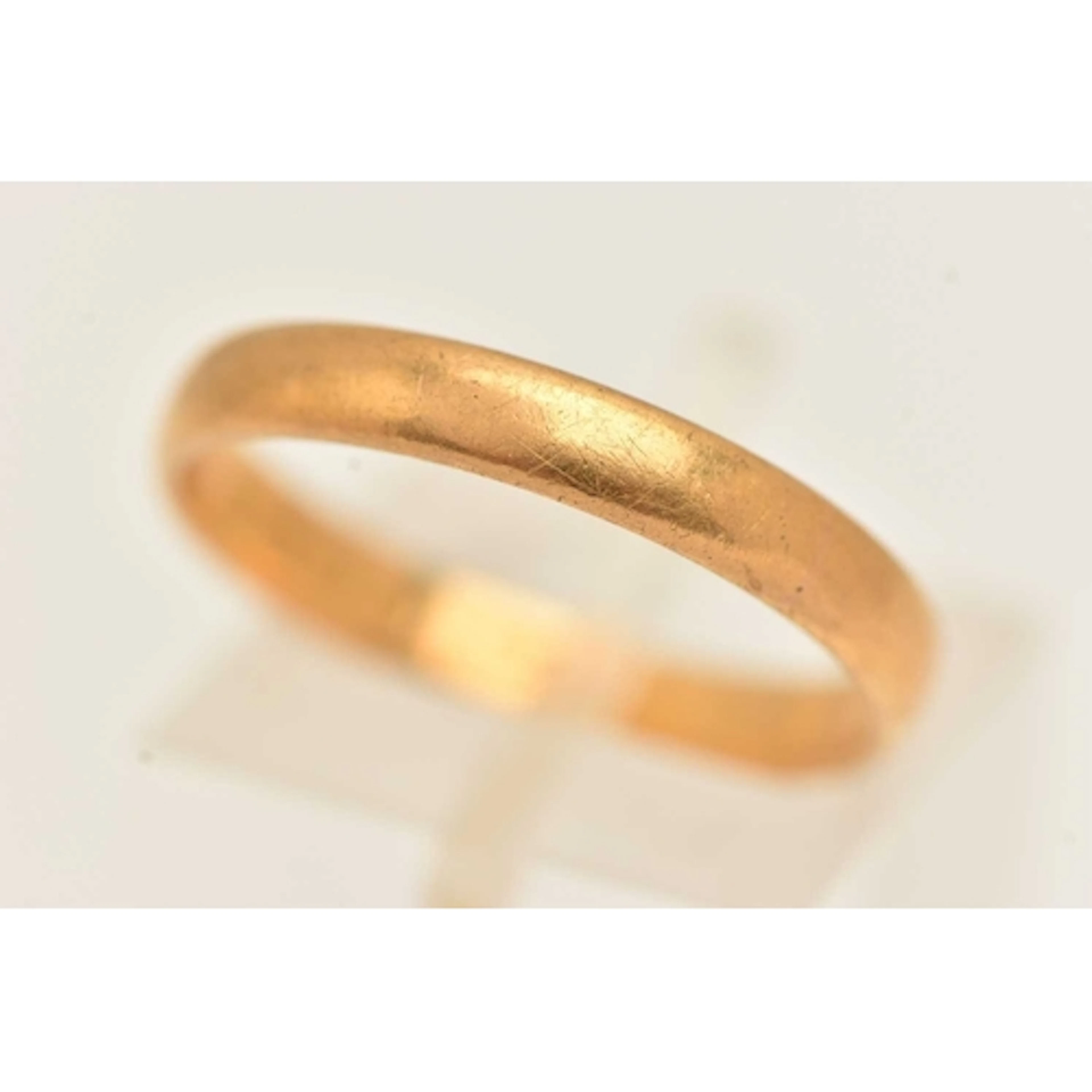 A 22CT GOLD BAND RING, approximate band width 3.2mm, hallmar...