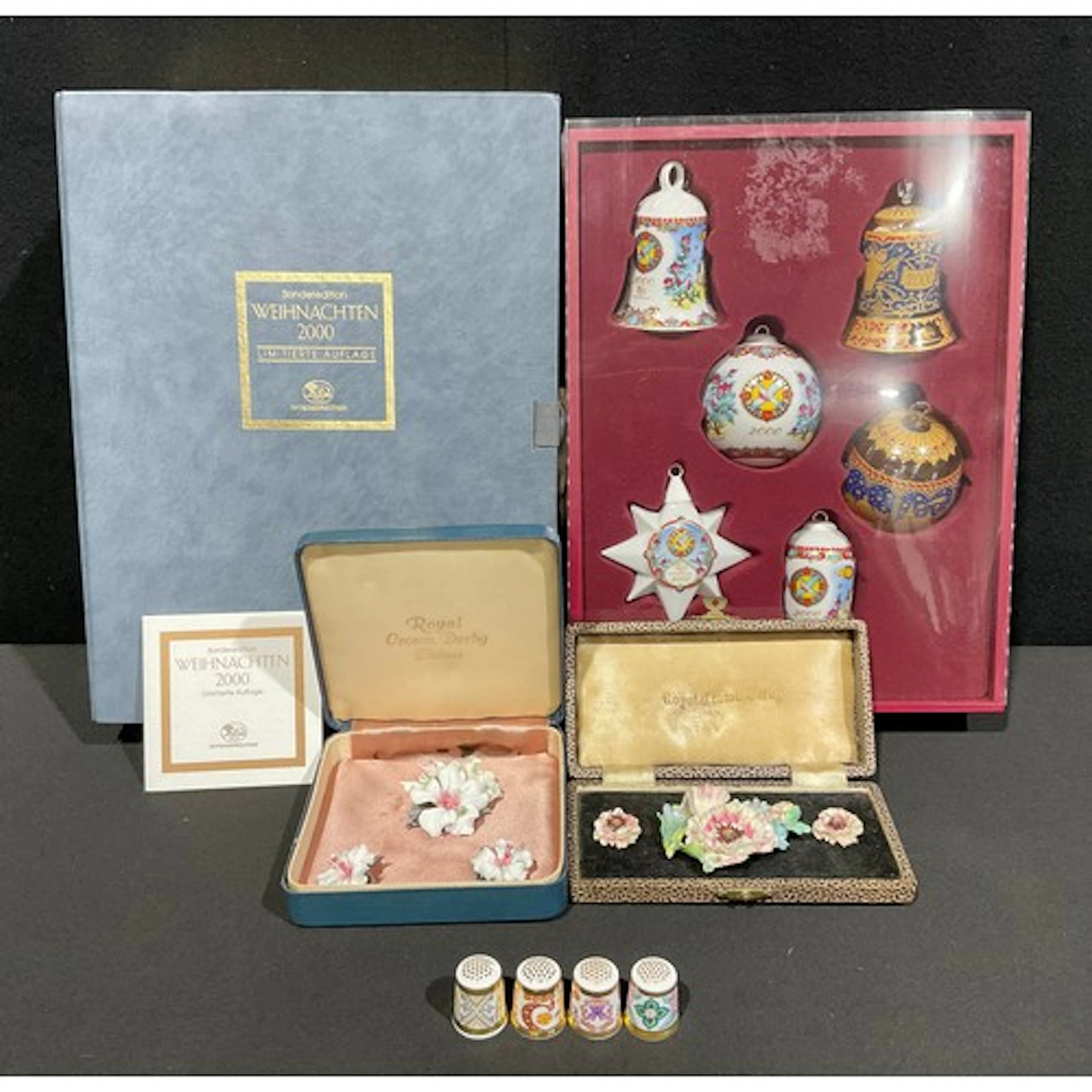 Royal Crown Derby - two cased floral earring and brooch sets...