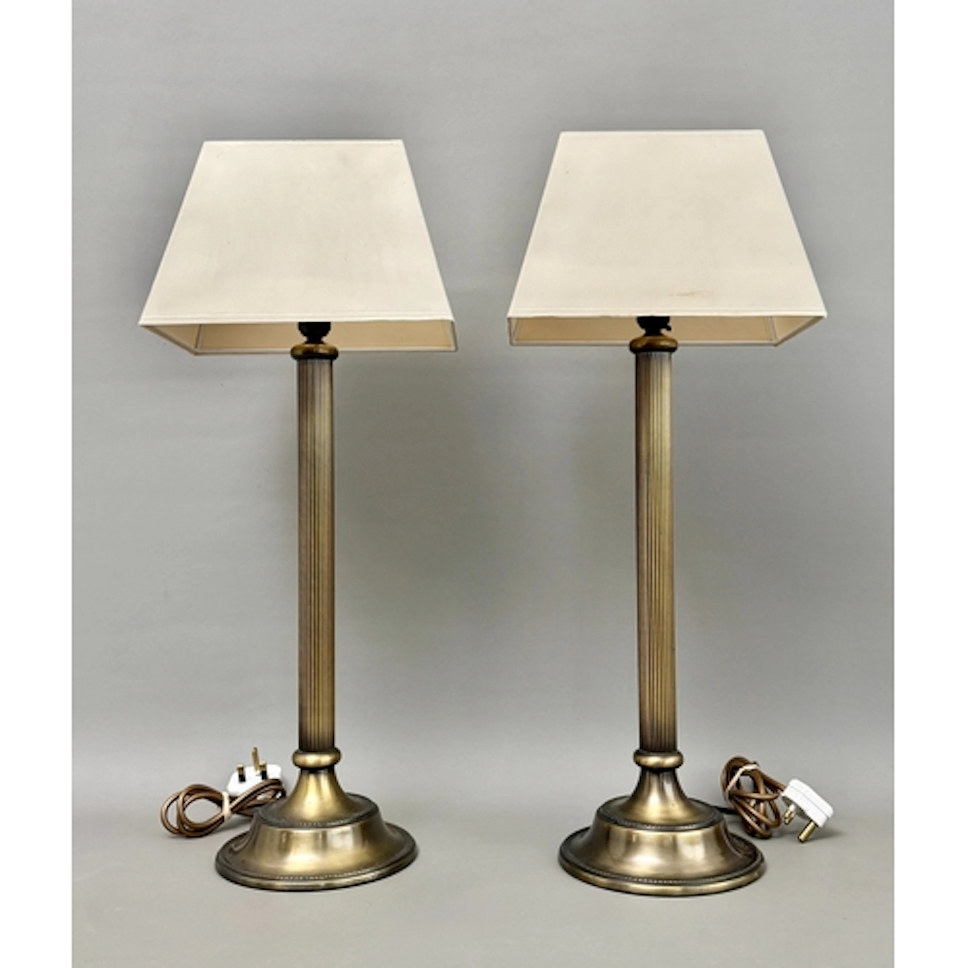 A pair of modern brass, reeded column stem table lamps - wit...