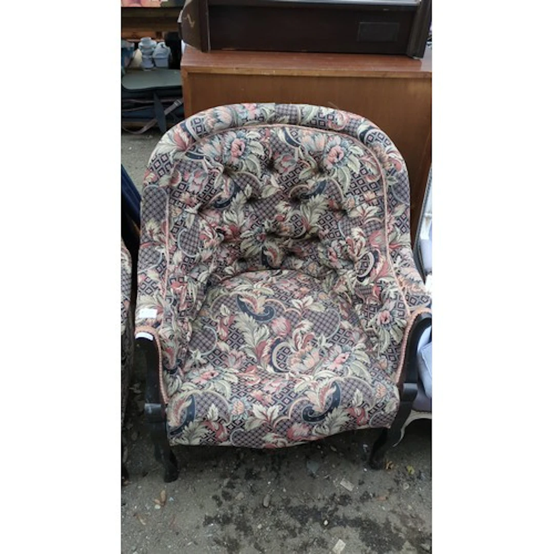 Upholstered armchair with a deep-buttoned rounded back, flor...