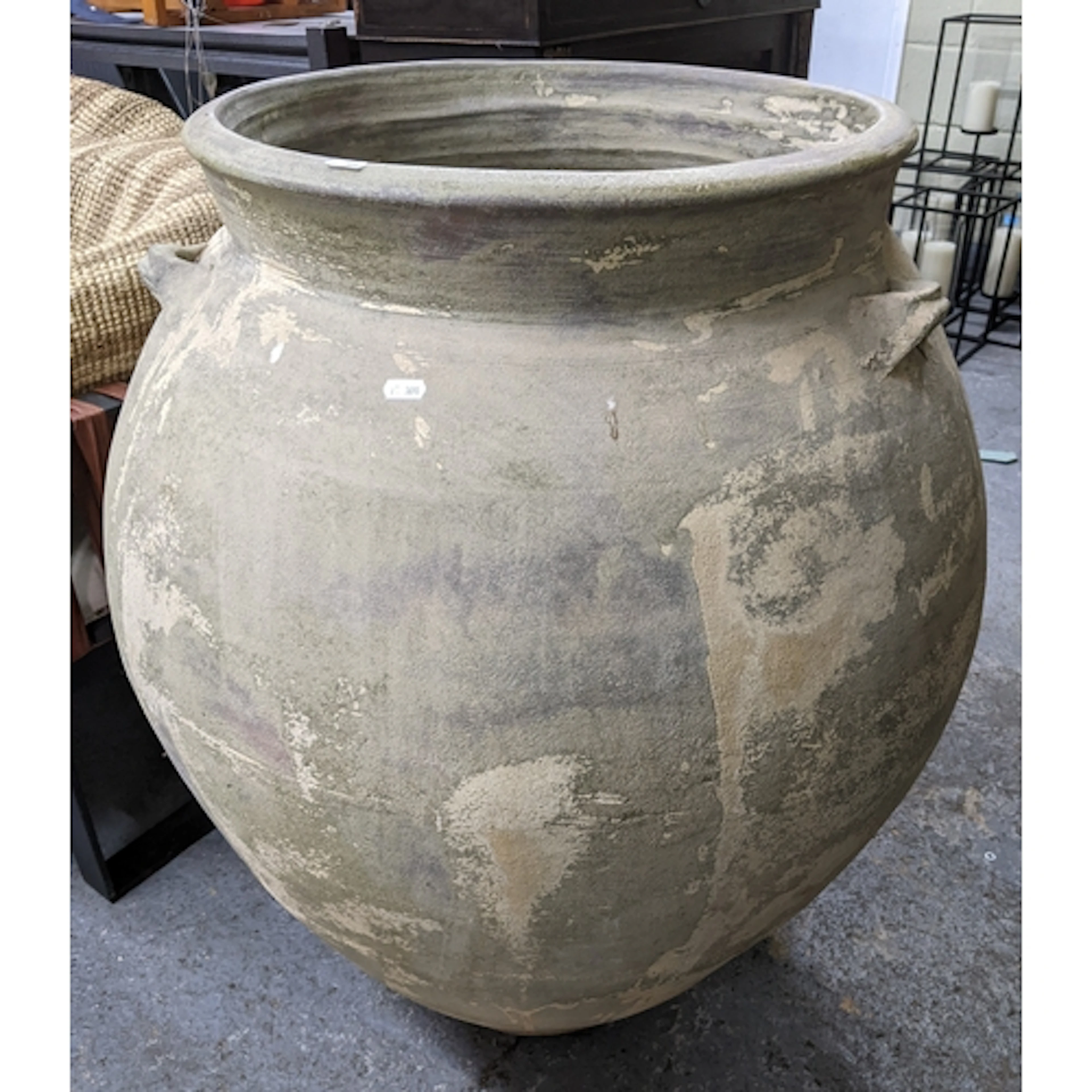 A large ceramic olive jar style garden planter, with three s...