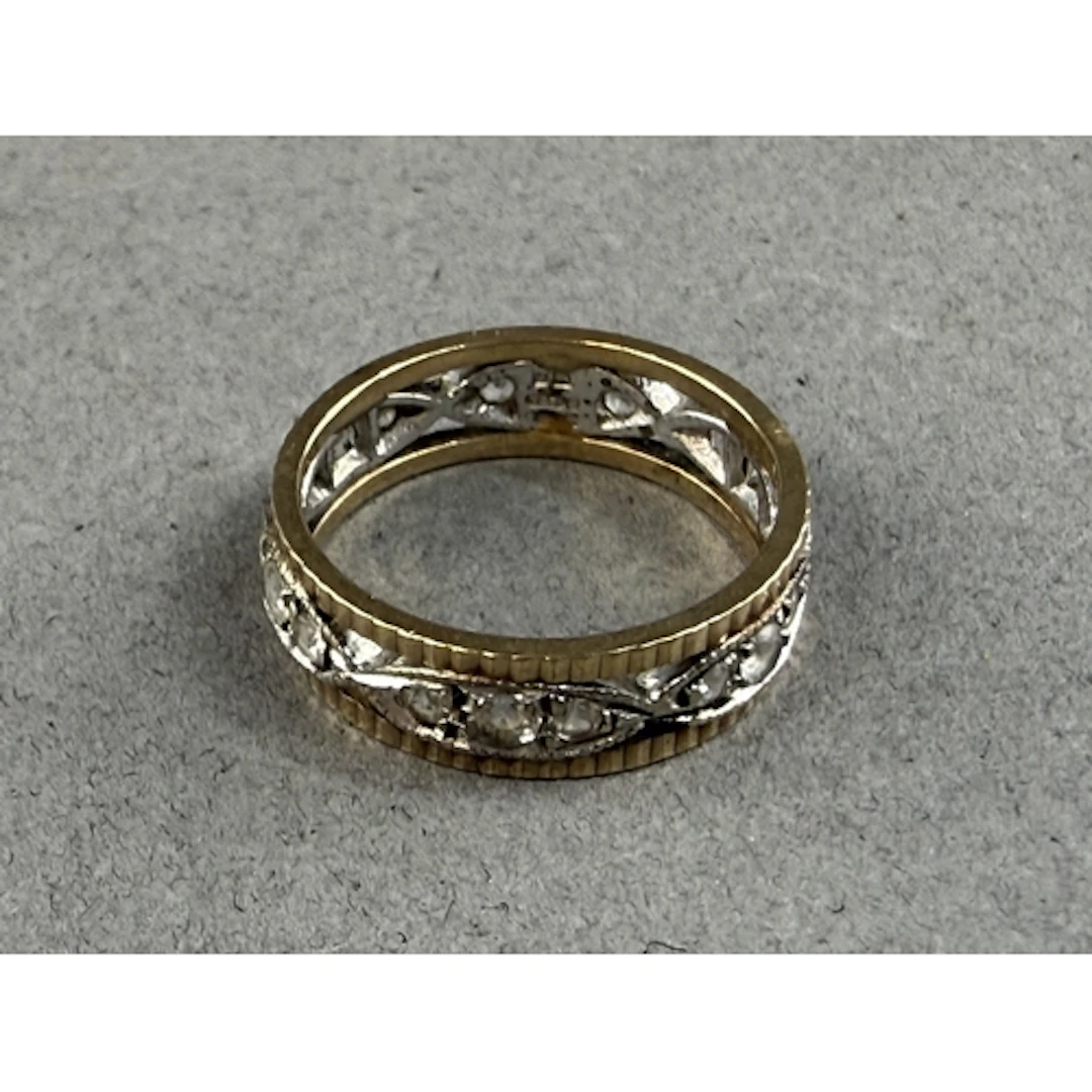 Jewellery: a 9ct yellow and white gold eternity ring set a b...