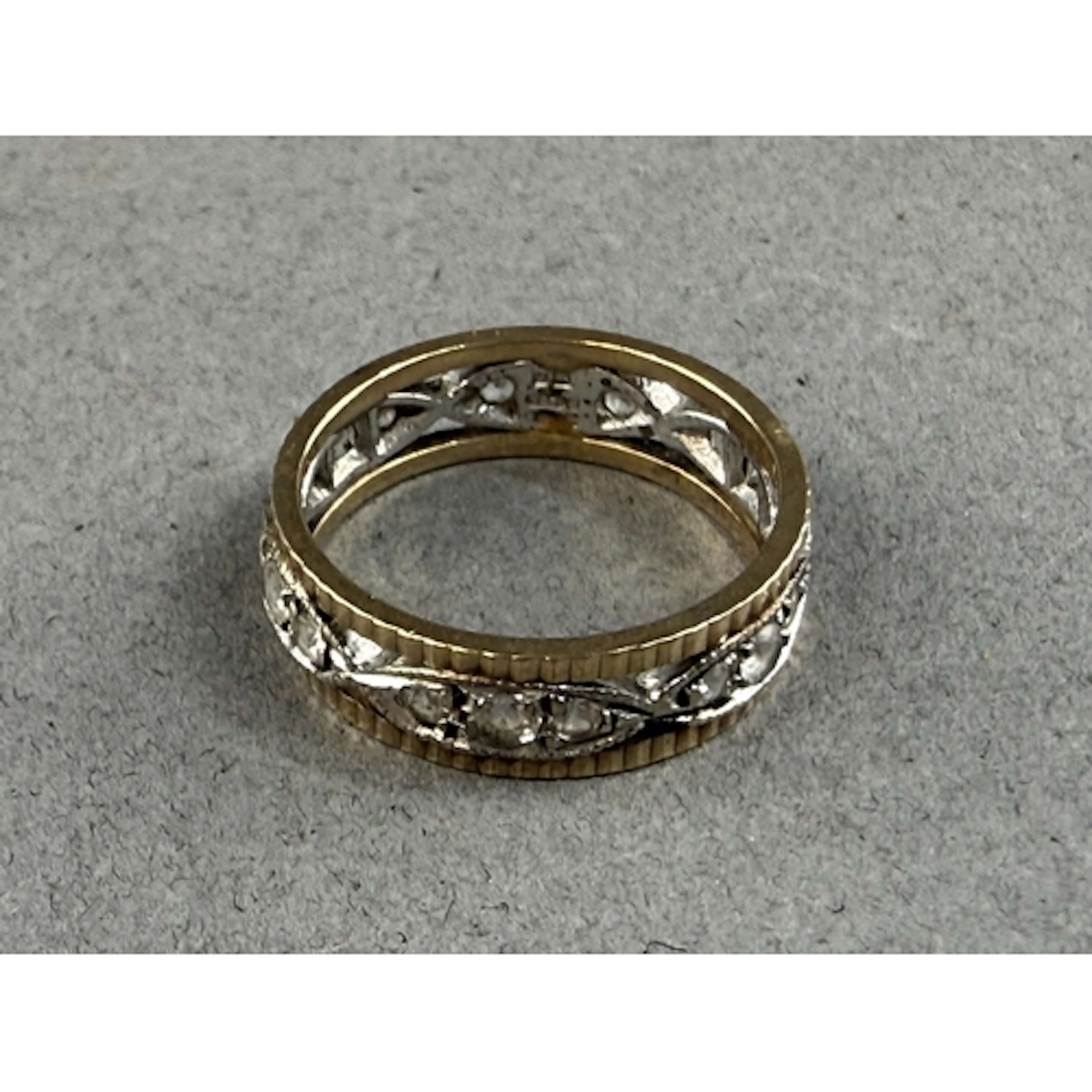 Jewellery: a 9ct yellow and white gold eternity ring set a b...