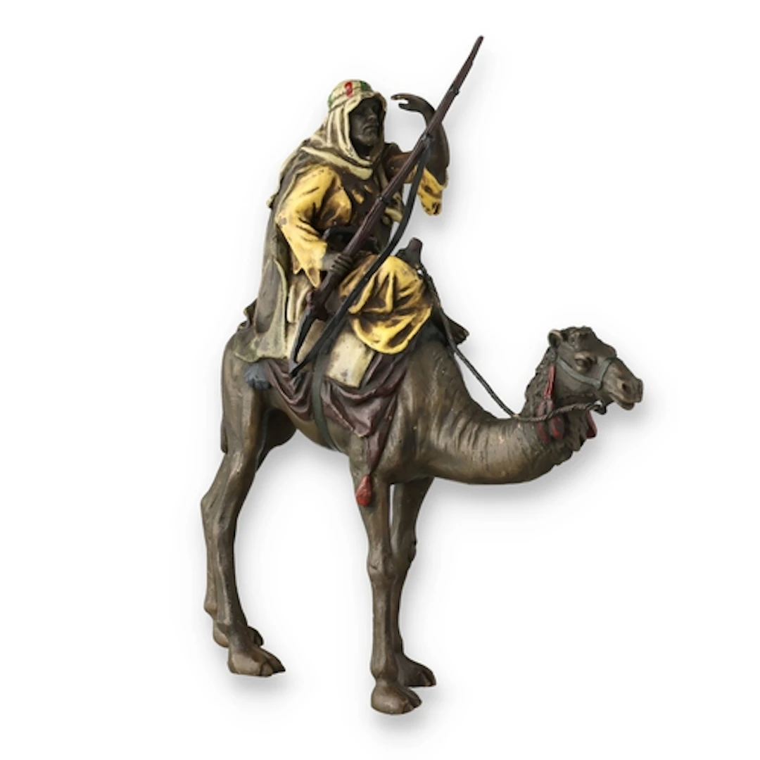 A COLD-PAINTED FIGURAL BRONZE Depcting a man on a camel. 20c...