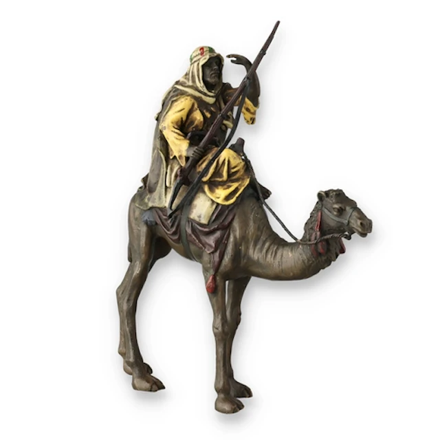 A COLD-PAINTED FIGURAL BRONZE Depcting a man on a camel. 20c...