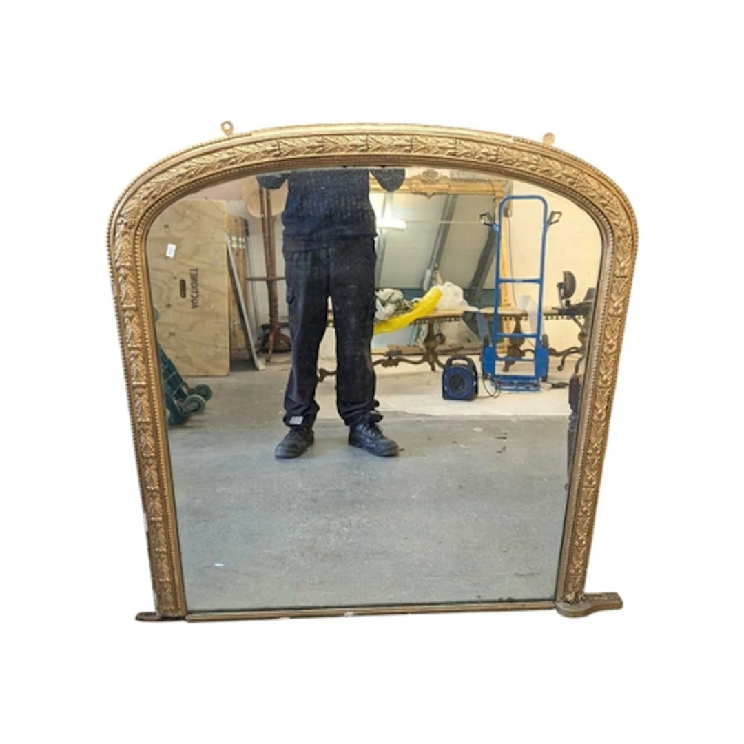 A 19th century gilt wood and gesso worked arched overmantel ...