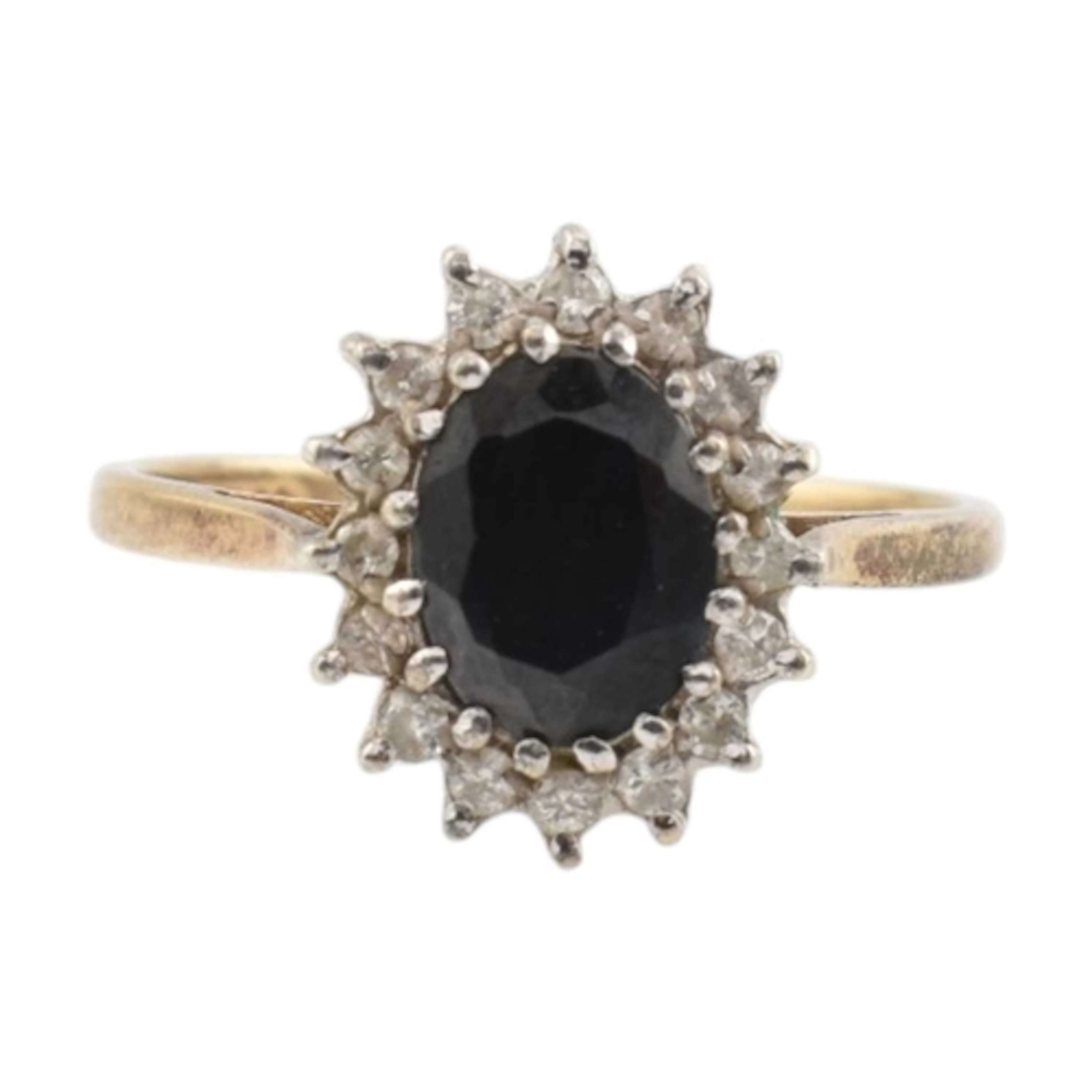 A 1980s hallmarked 9ct gold sapphire and diamond halo ring. ...