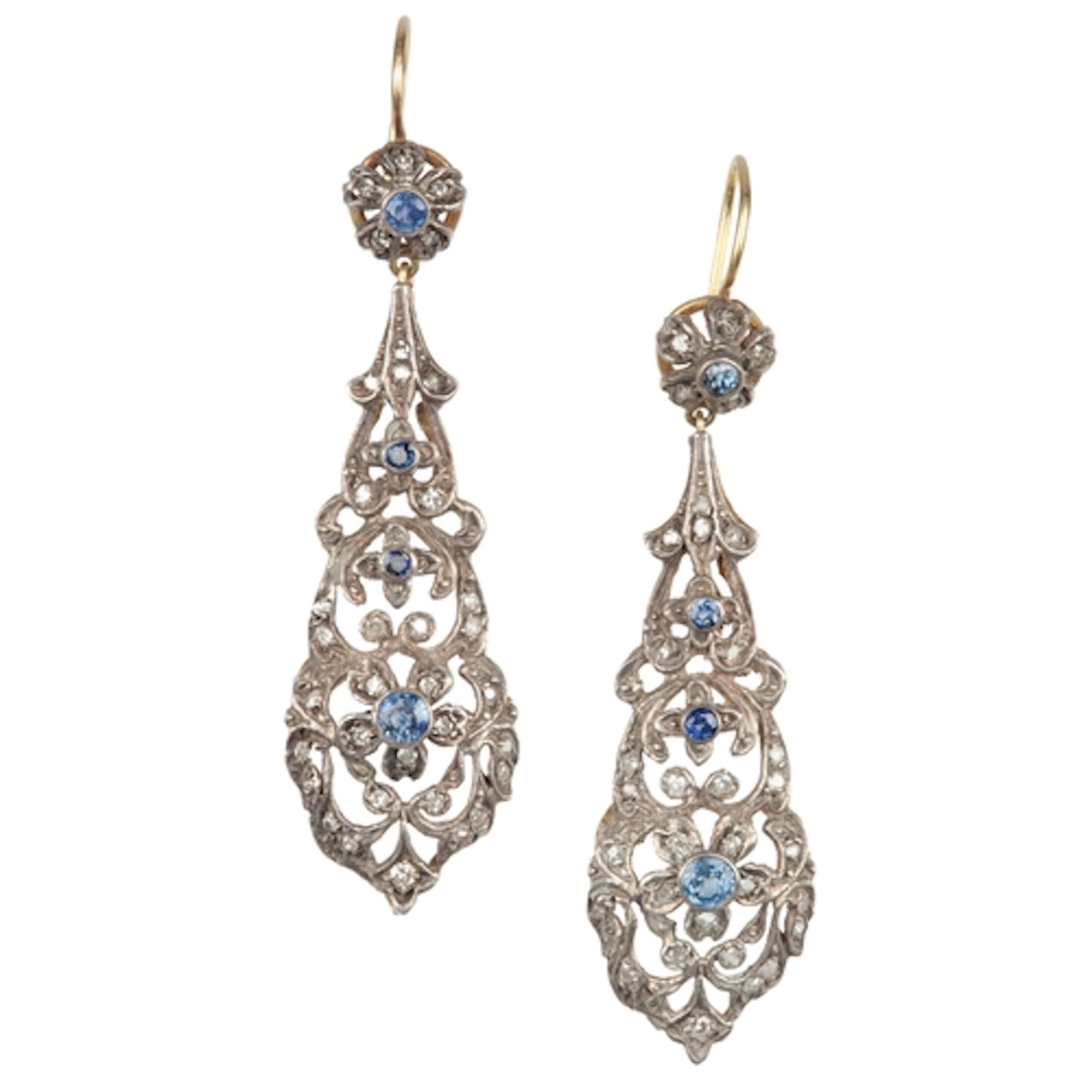A pair of sapphire and diamond earrings, each designed as a ...