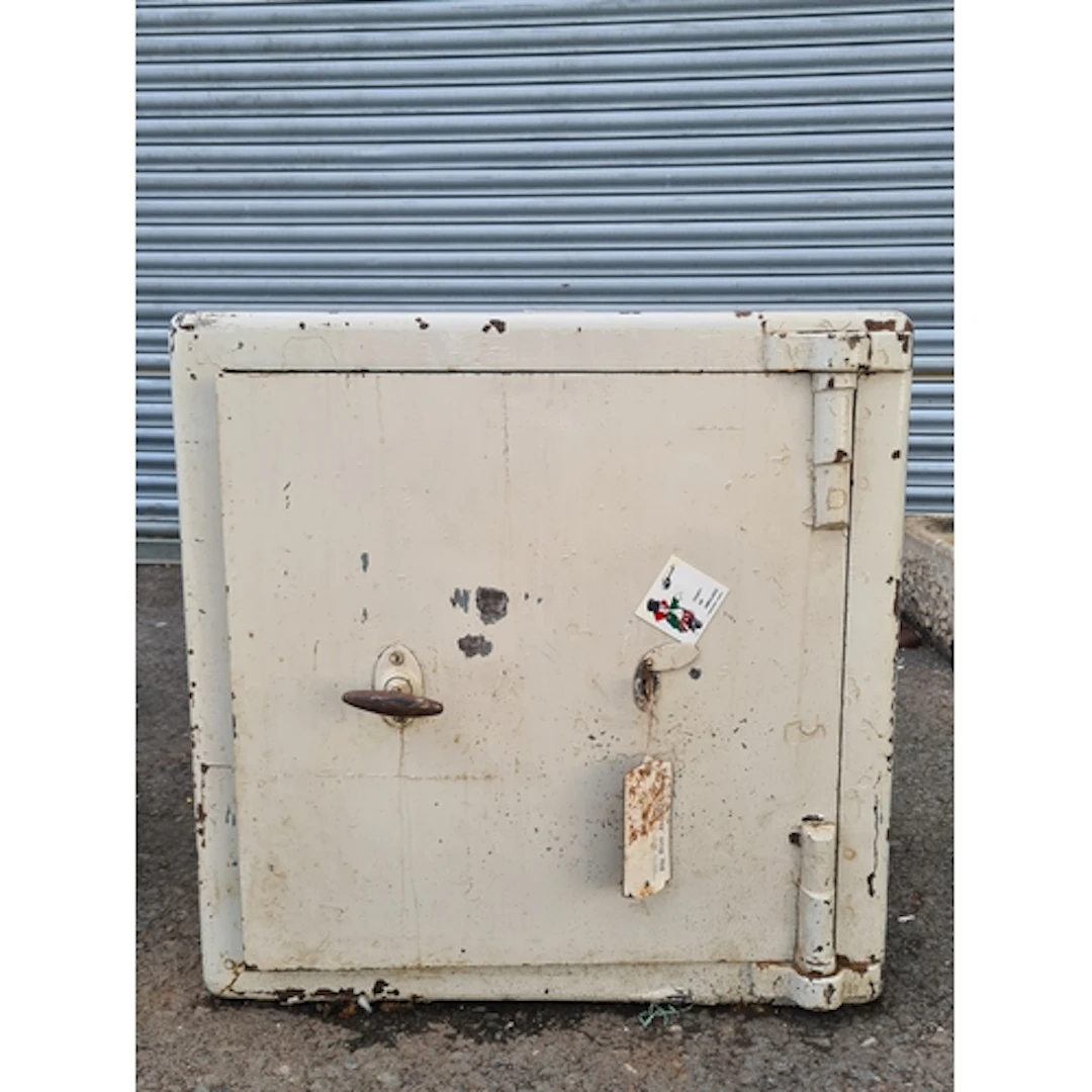 A white painted Safe, complete with Key.