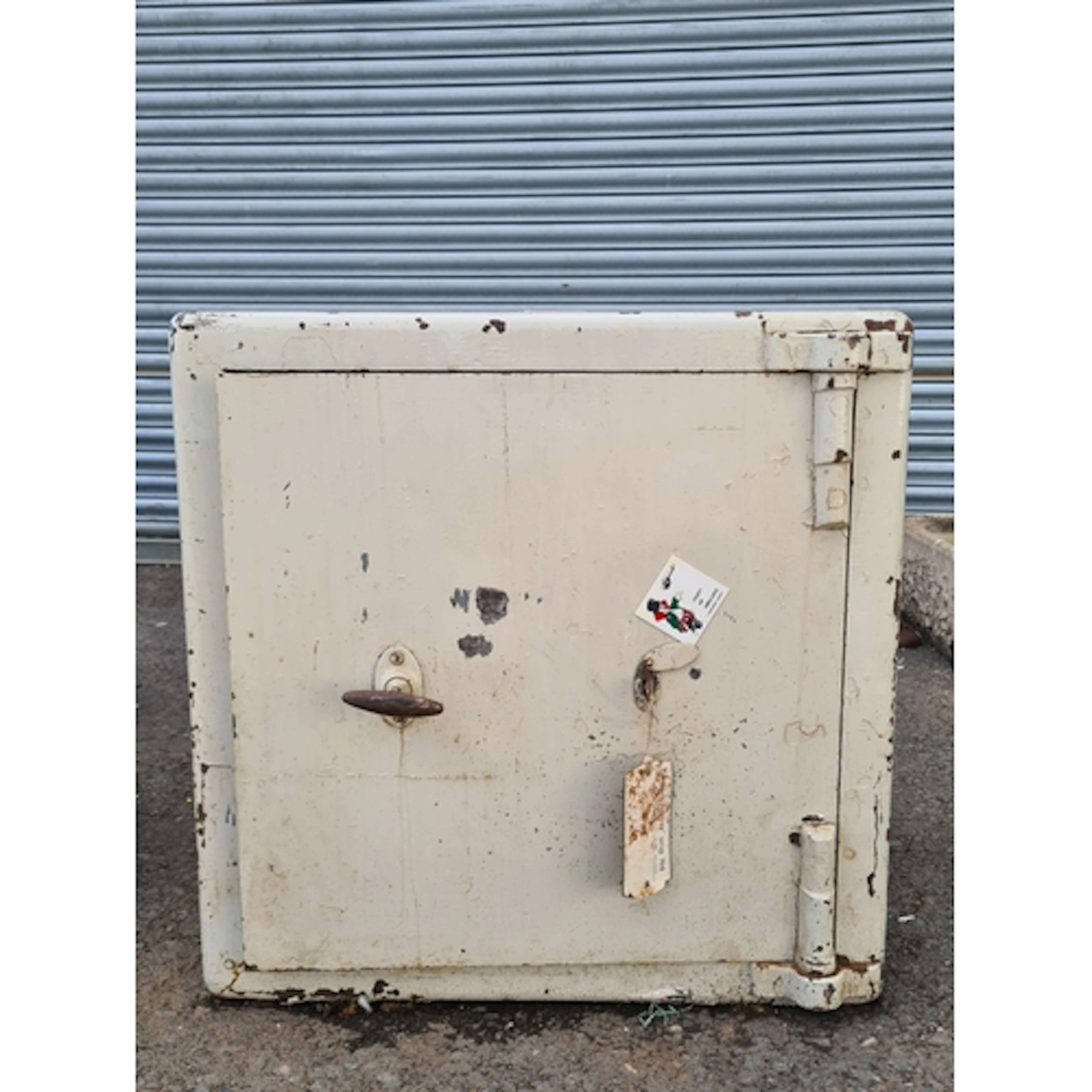 A white painted Safe, complete with Key.
