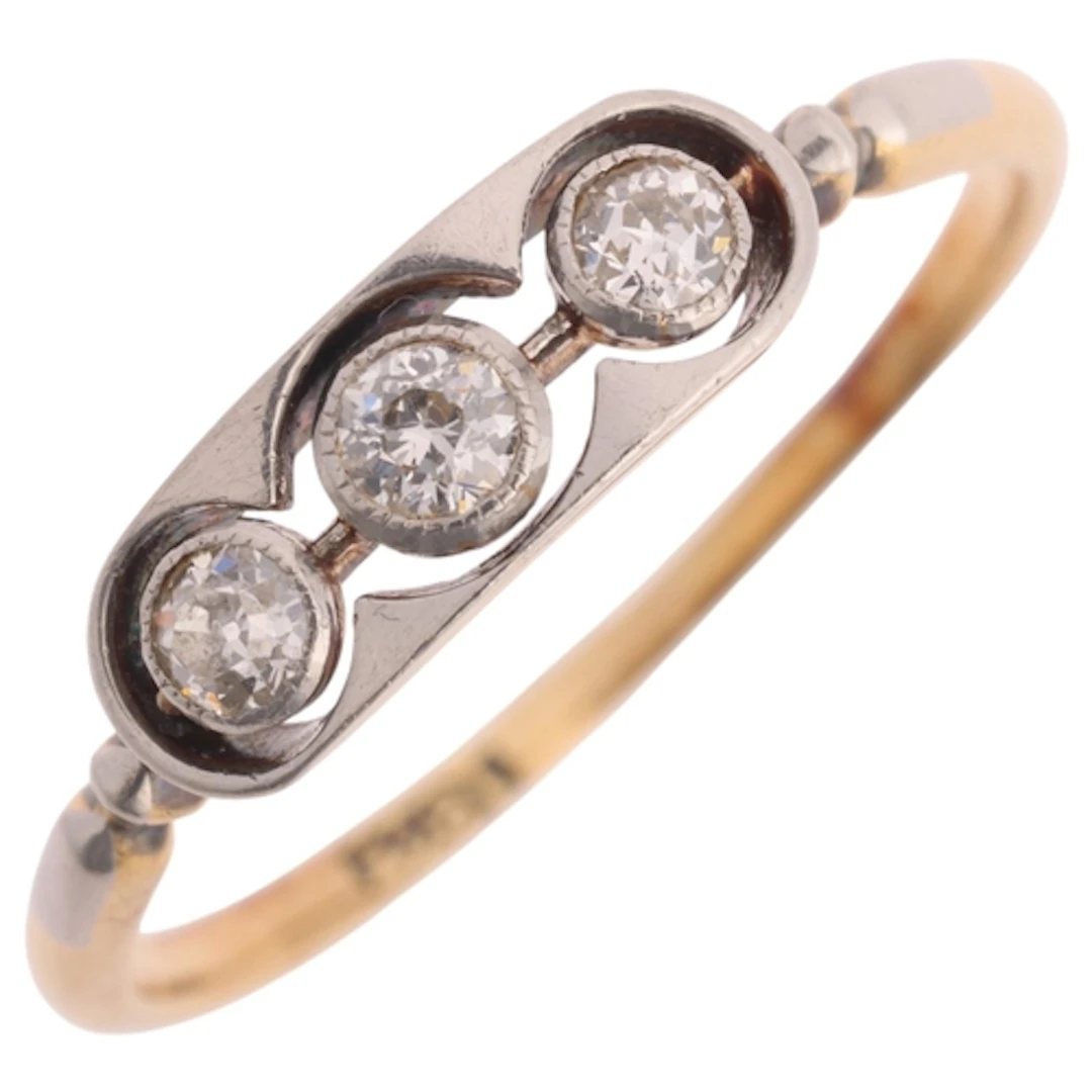 An 18ct gold three stone diamond ring, in the Art Deco style...
