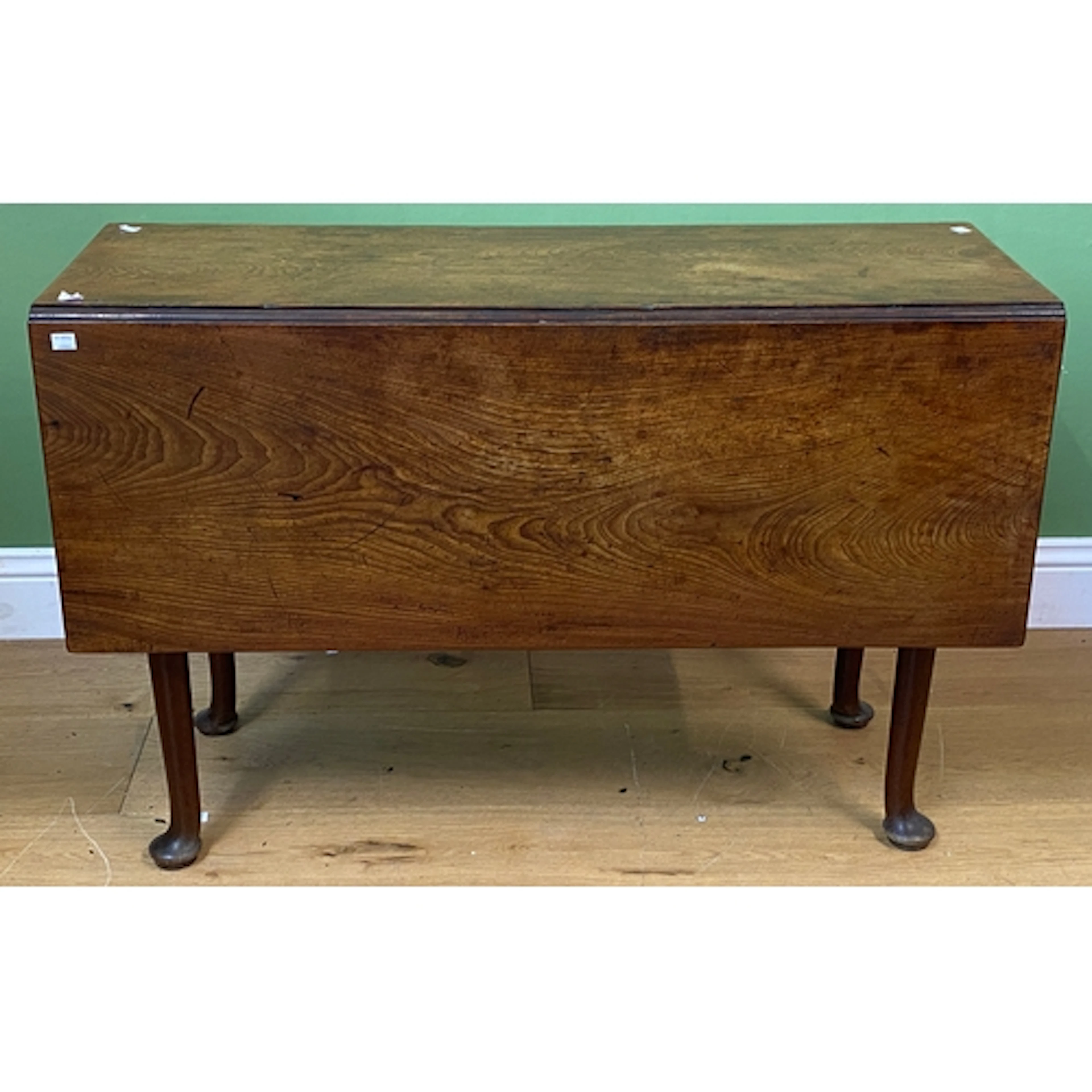A George II mahogany rectangular gateleg table with pad feet...