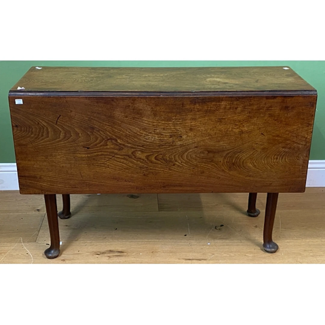 A George II mahogany rectangular gateleg table with pad feet...