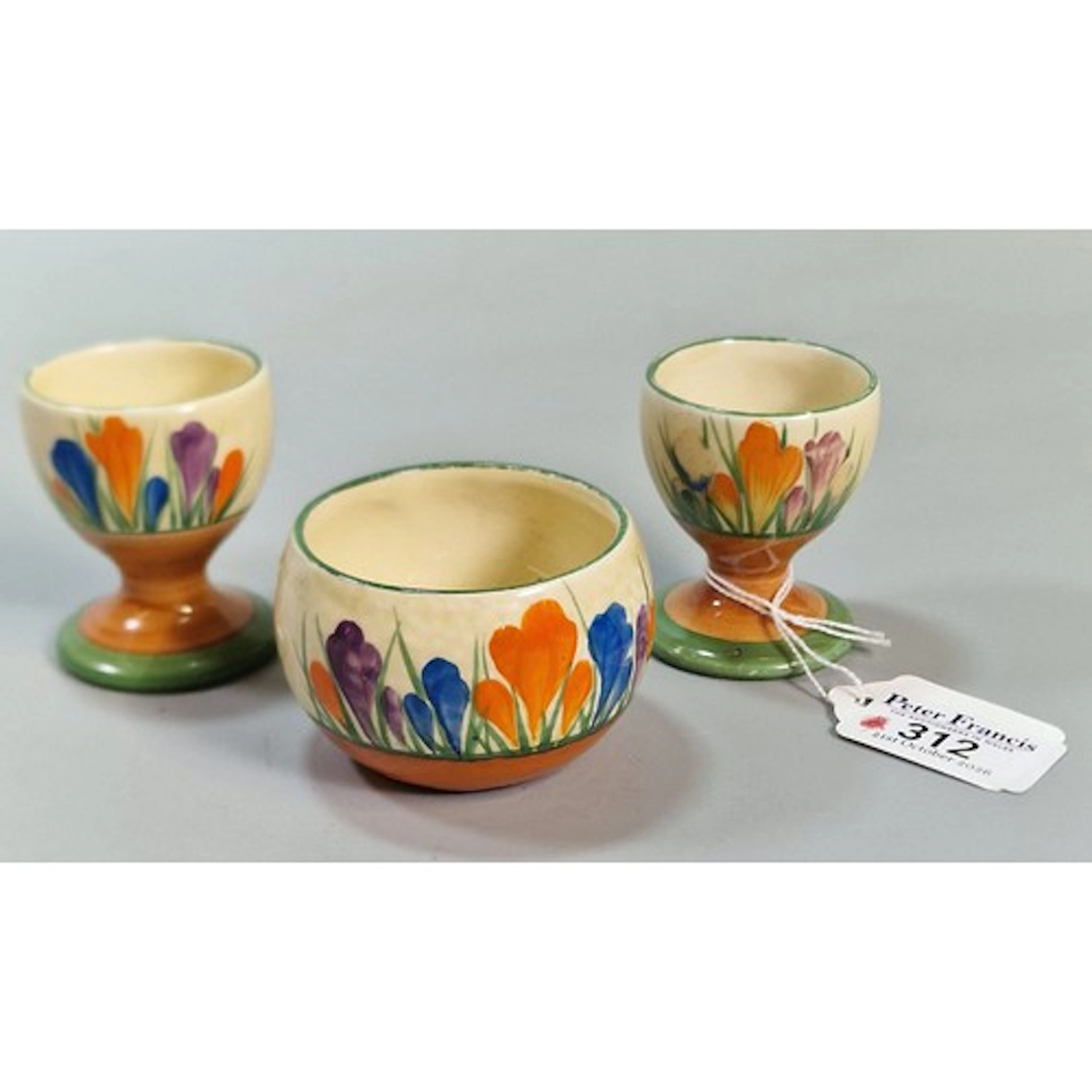 Two similar Clarice Cliff 'Crocus' design egg cups, together...