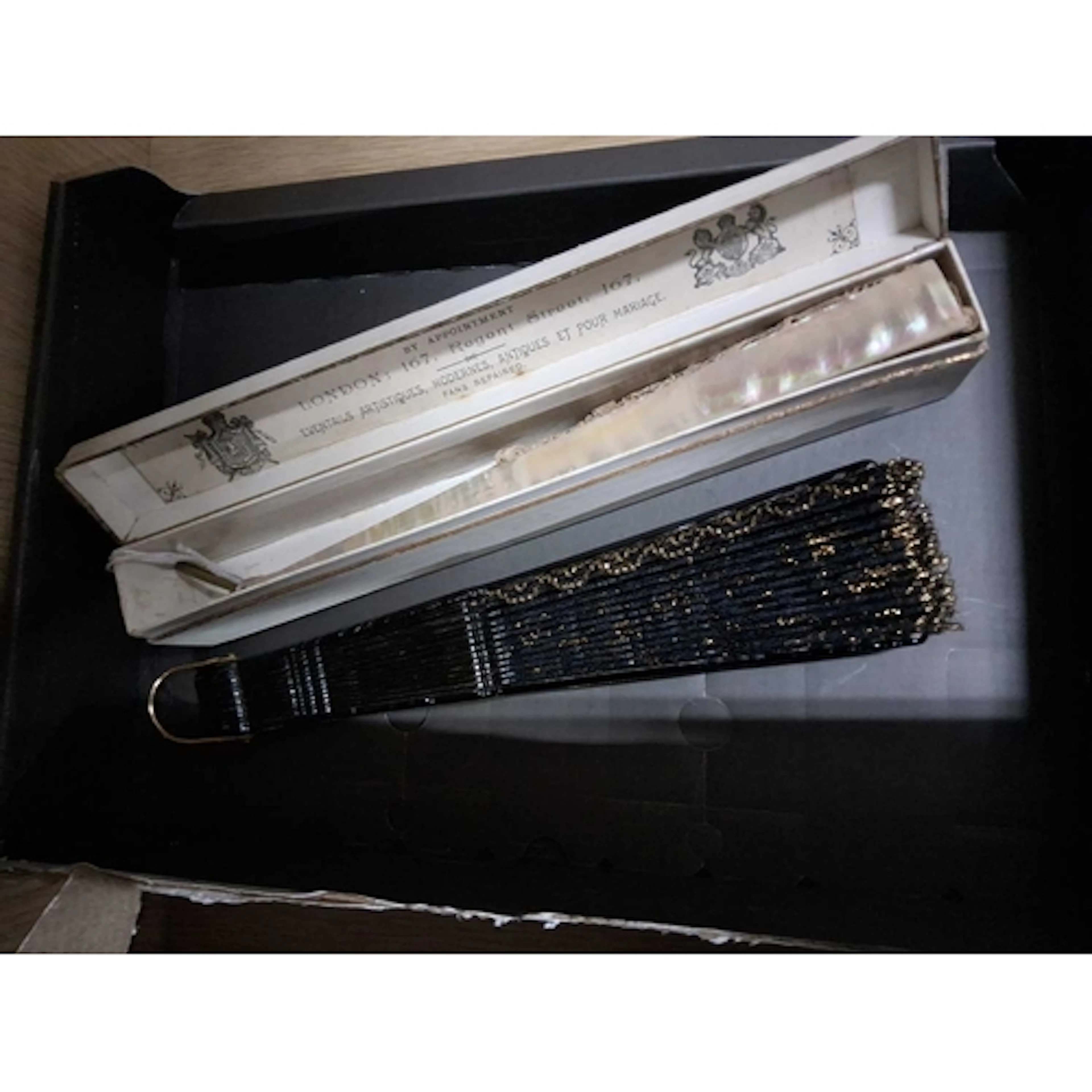 A MOTHER OF PEARL FAN AND ANOTHER, comprising a boxed lace a...