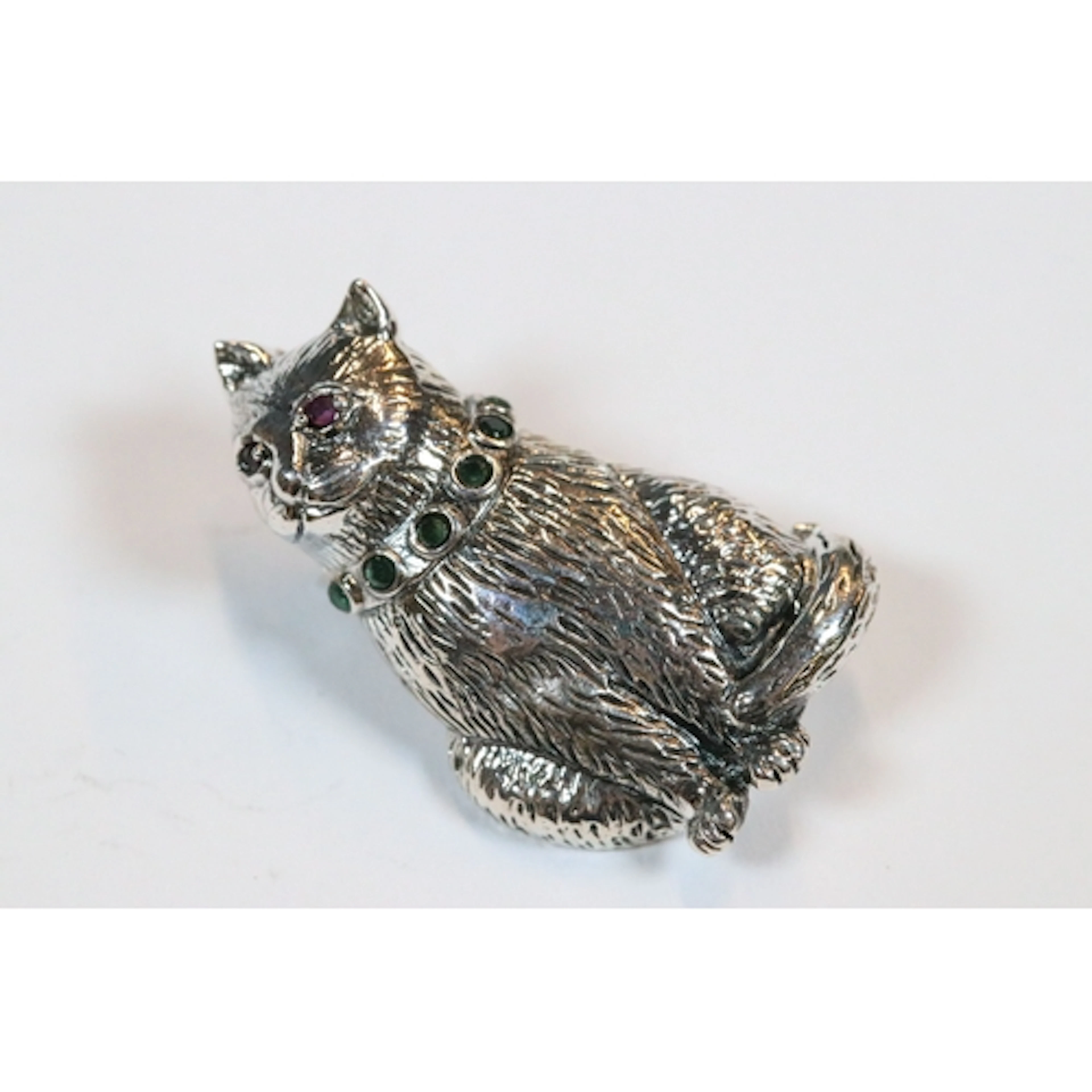 Silver cat brooch with emerald collar and ruby eyes
