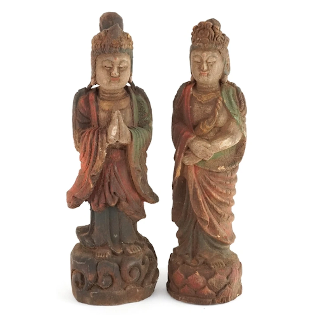 Two carved wooden figures of deities, the largest 30.5cm hig...